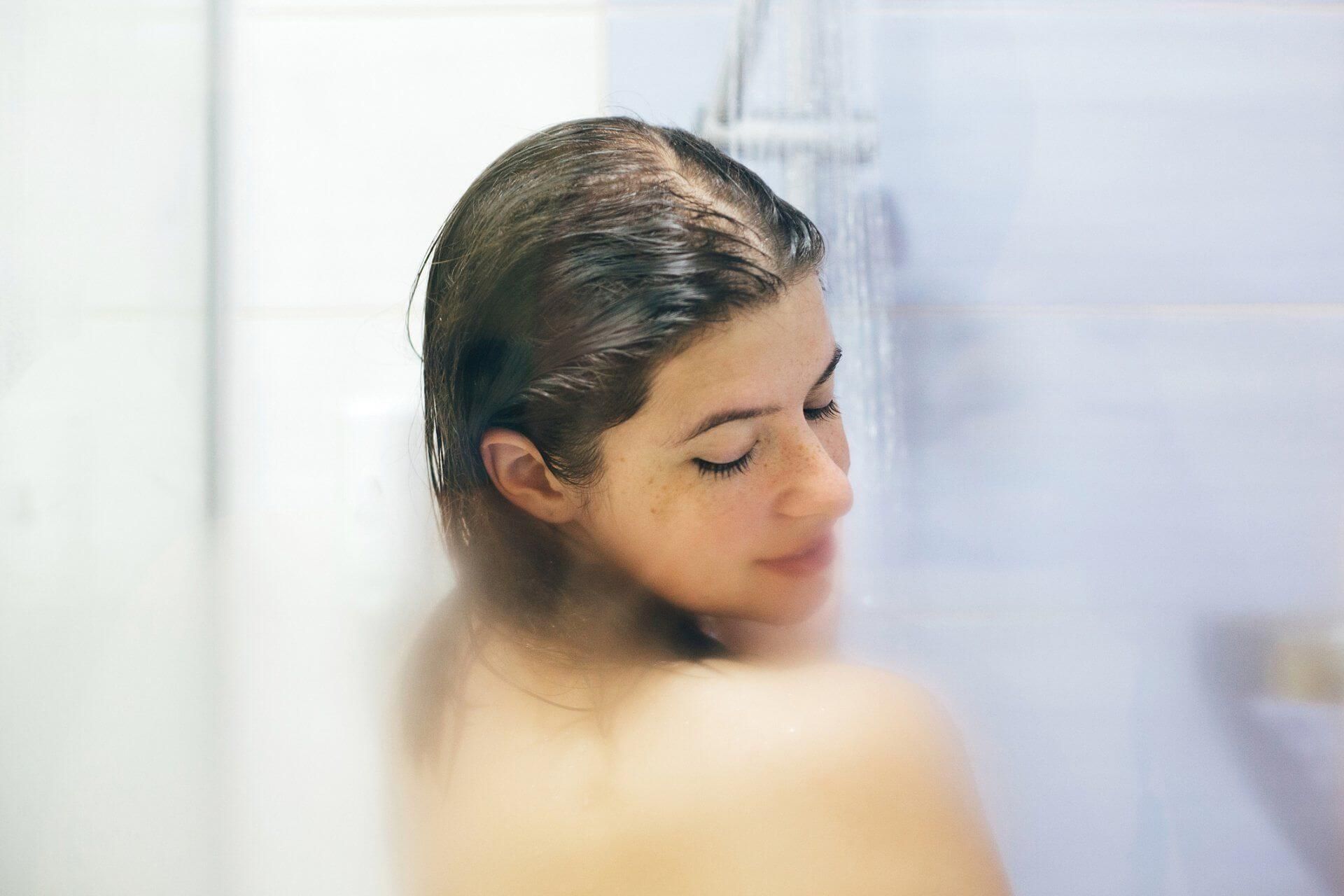 Young Woman Taking Shower — Chicagoland — J&S Plumbing Inc. Young Woman Taking Shower — Chicagoland — J&S Plumbing Inc.