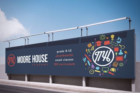 A large billboard for moore house with a blue sky in the background