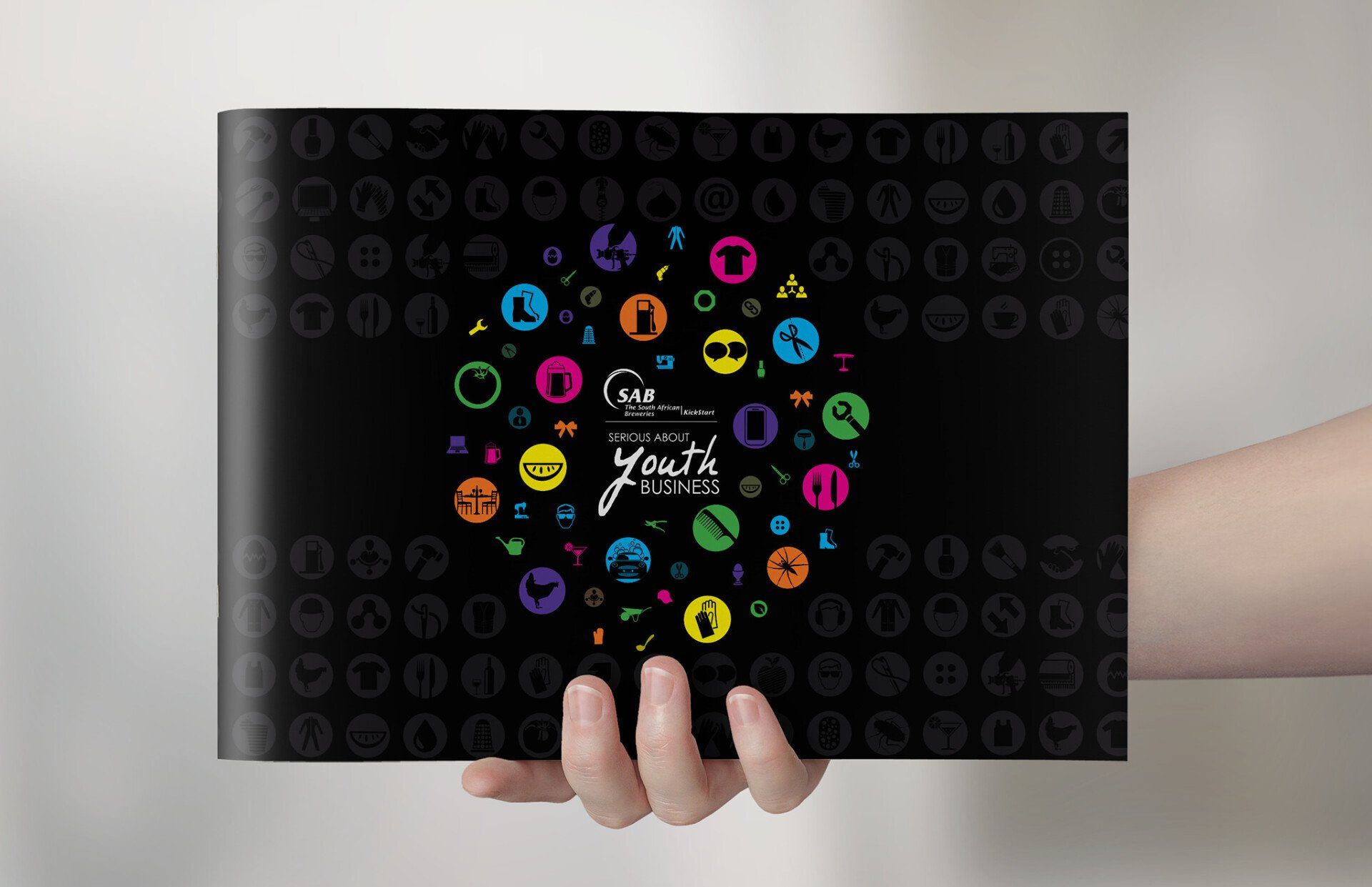 A person is holding a book with a colorful design on it