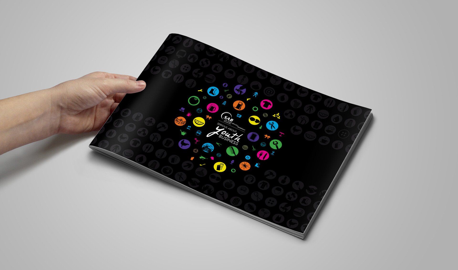 A person is holding a book with a colorful design on it