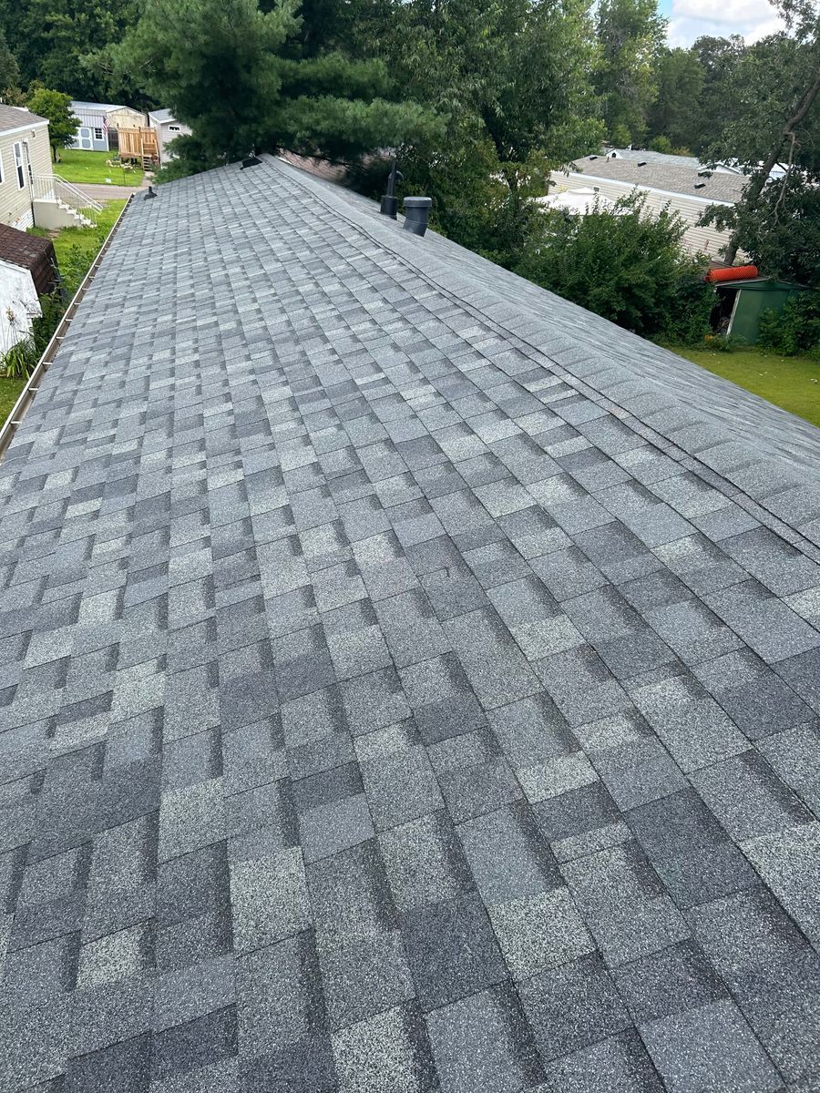 A close up of a roof with a lot of shingles on it.