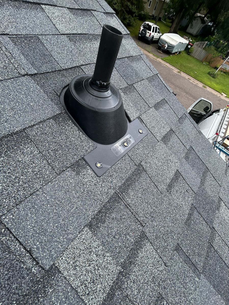 A close up of a roof with a chimney on it.