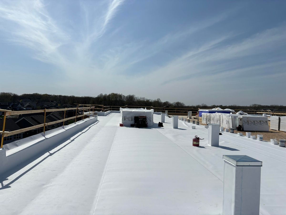 A large white roof with a blue sky in the background.
