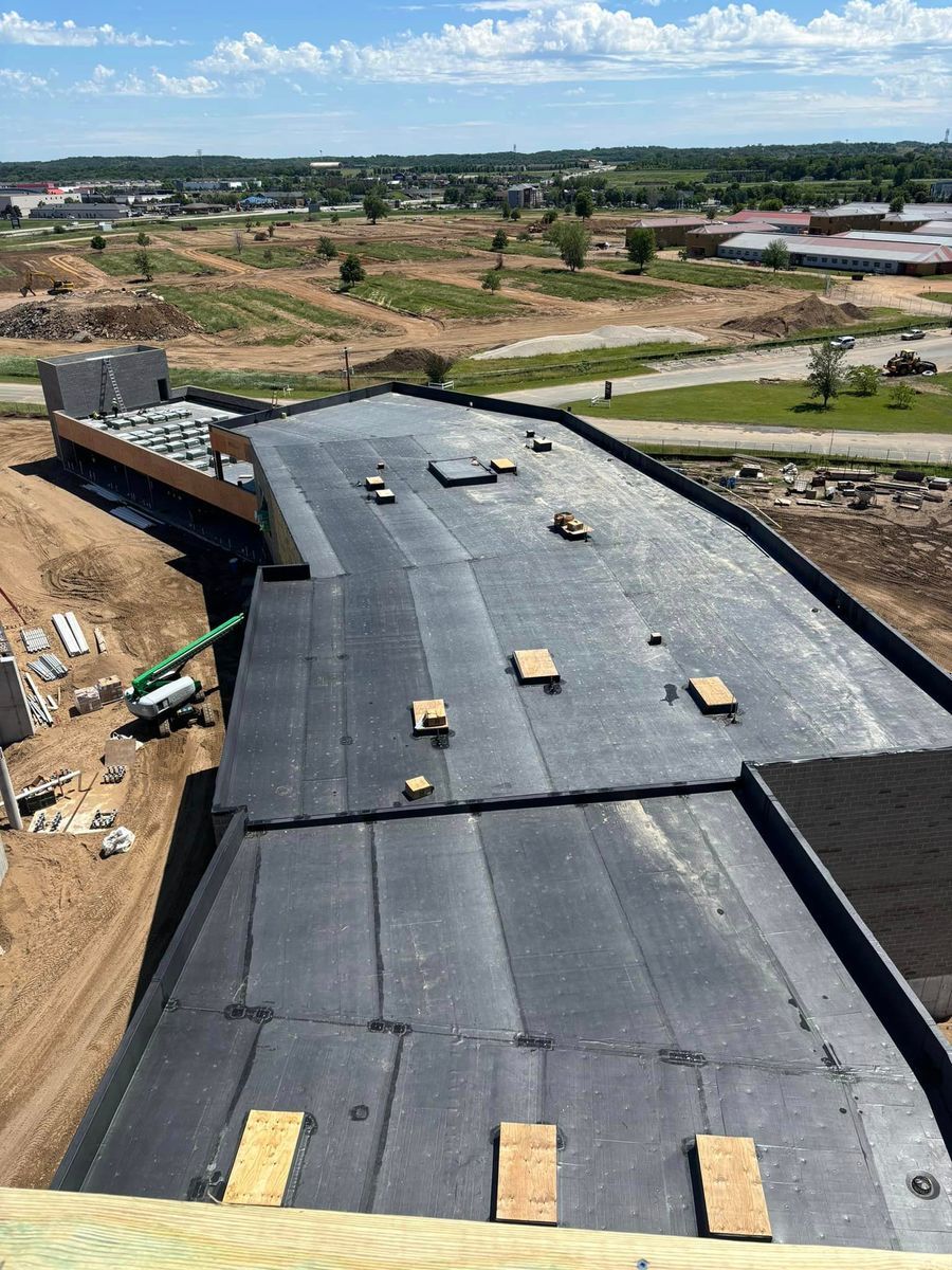 A large black roof is being built on top of a building.