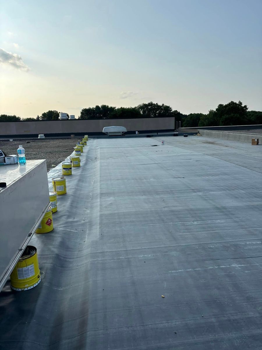A roof with a lot of yellow buckets on it.