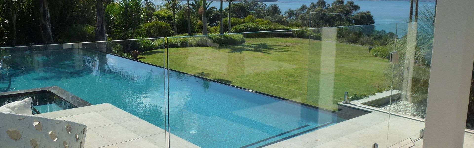 Modern backyard infinity pool with ocean view and lounge area — KLS Fencing In Mossman, QLD