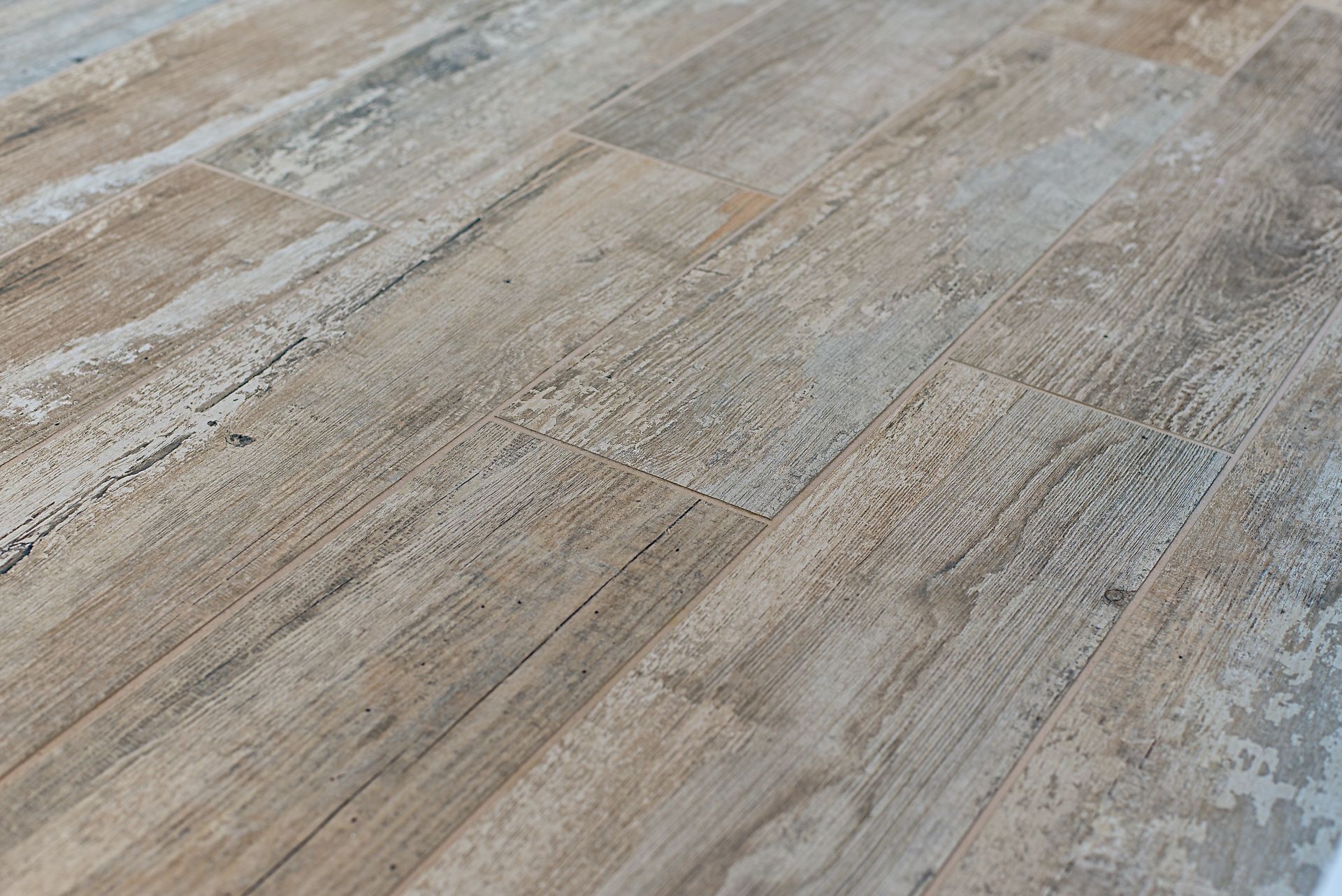 Light brown and gray distressed wood-look tile floor.