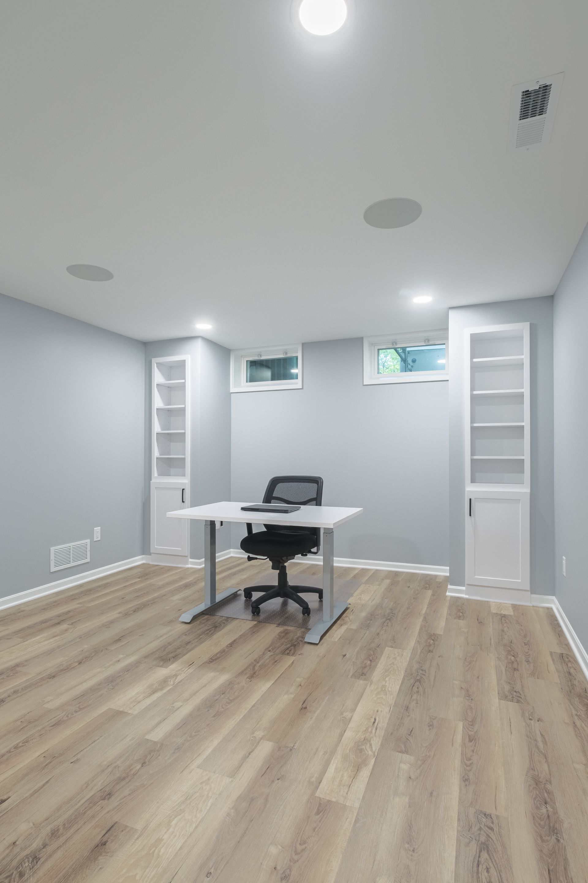There is a desk and chair in the middle of the room.