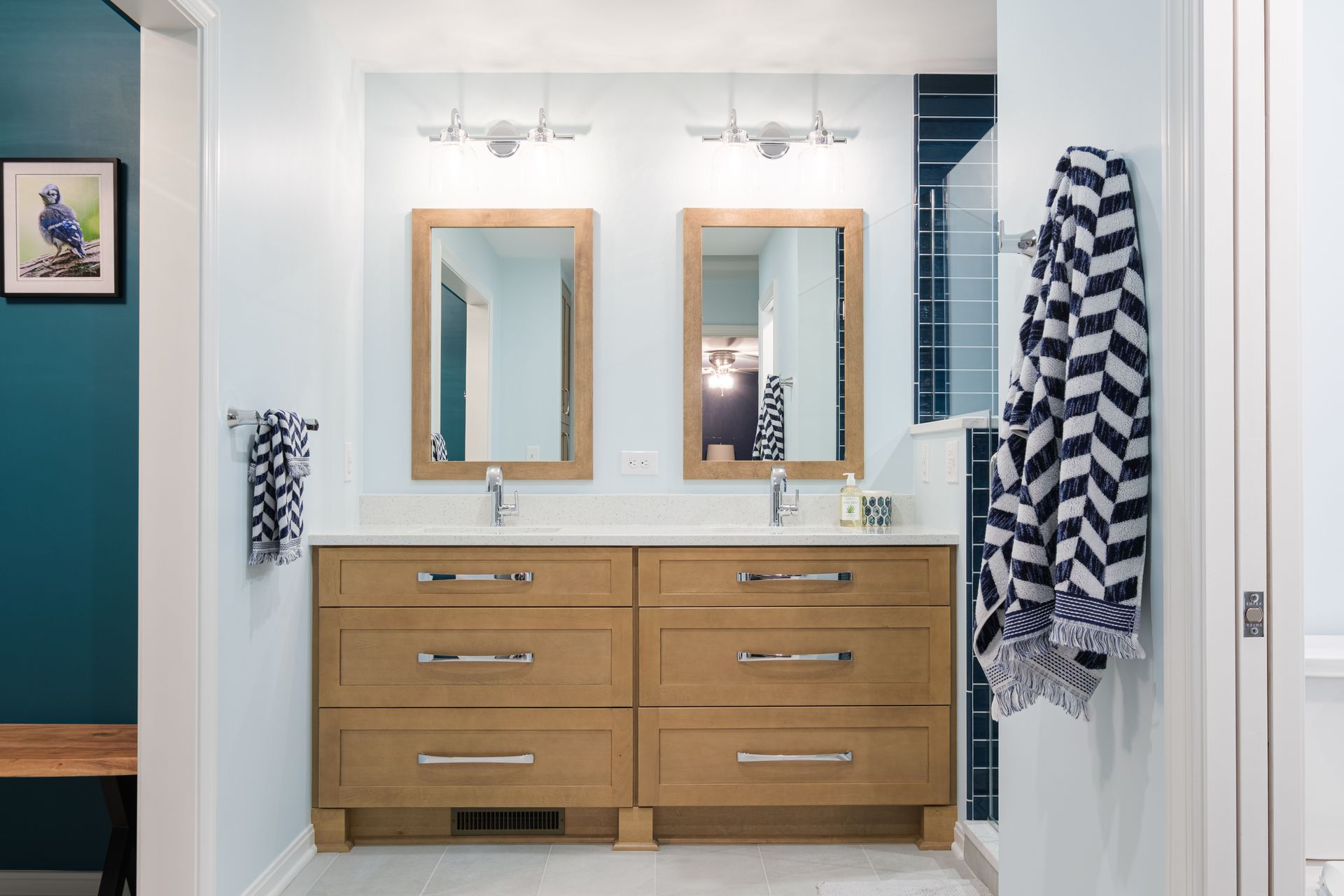 A bathroom with two sinks and two mirrors.