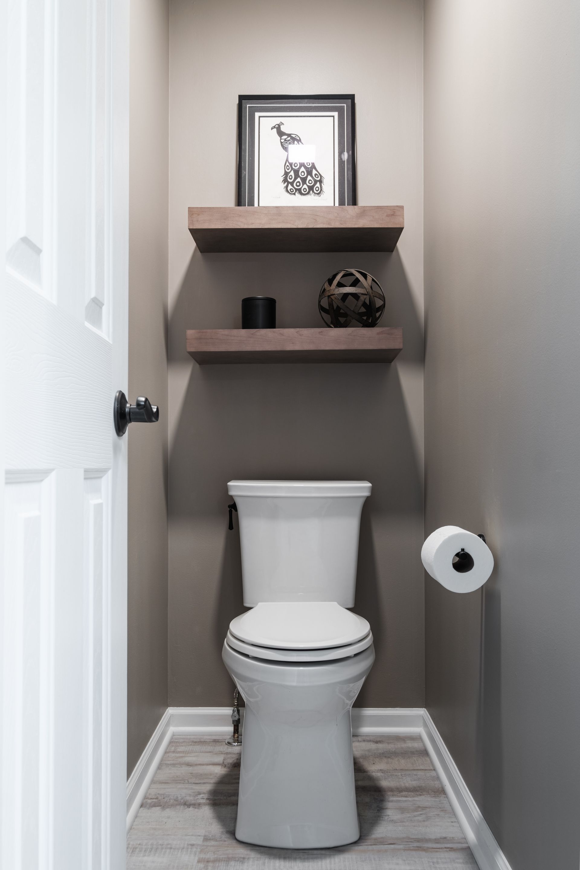 A toilet is sitting in a small bathroom next to a door.