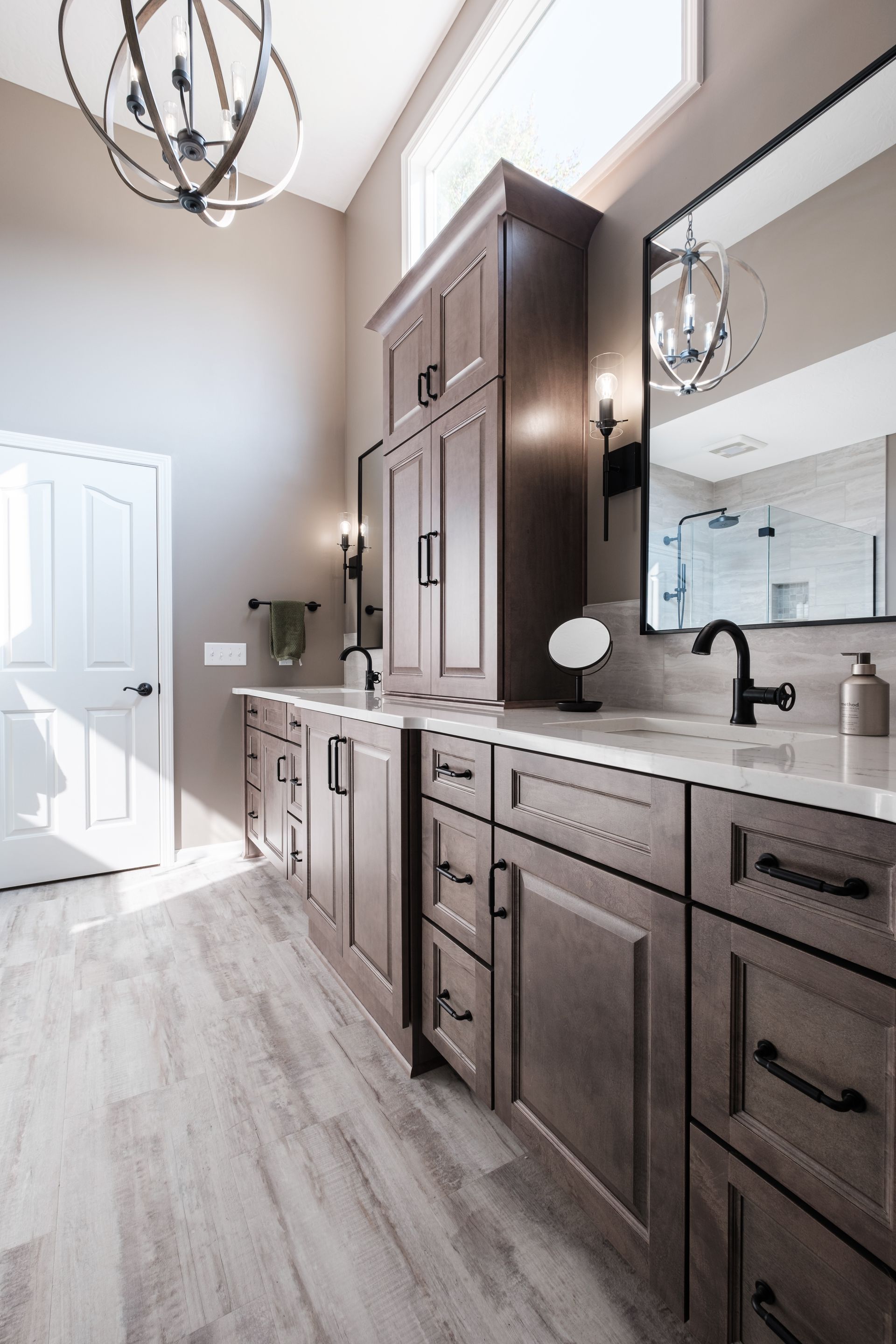 A bathroom with two sinks and a large mirror.
