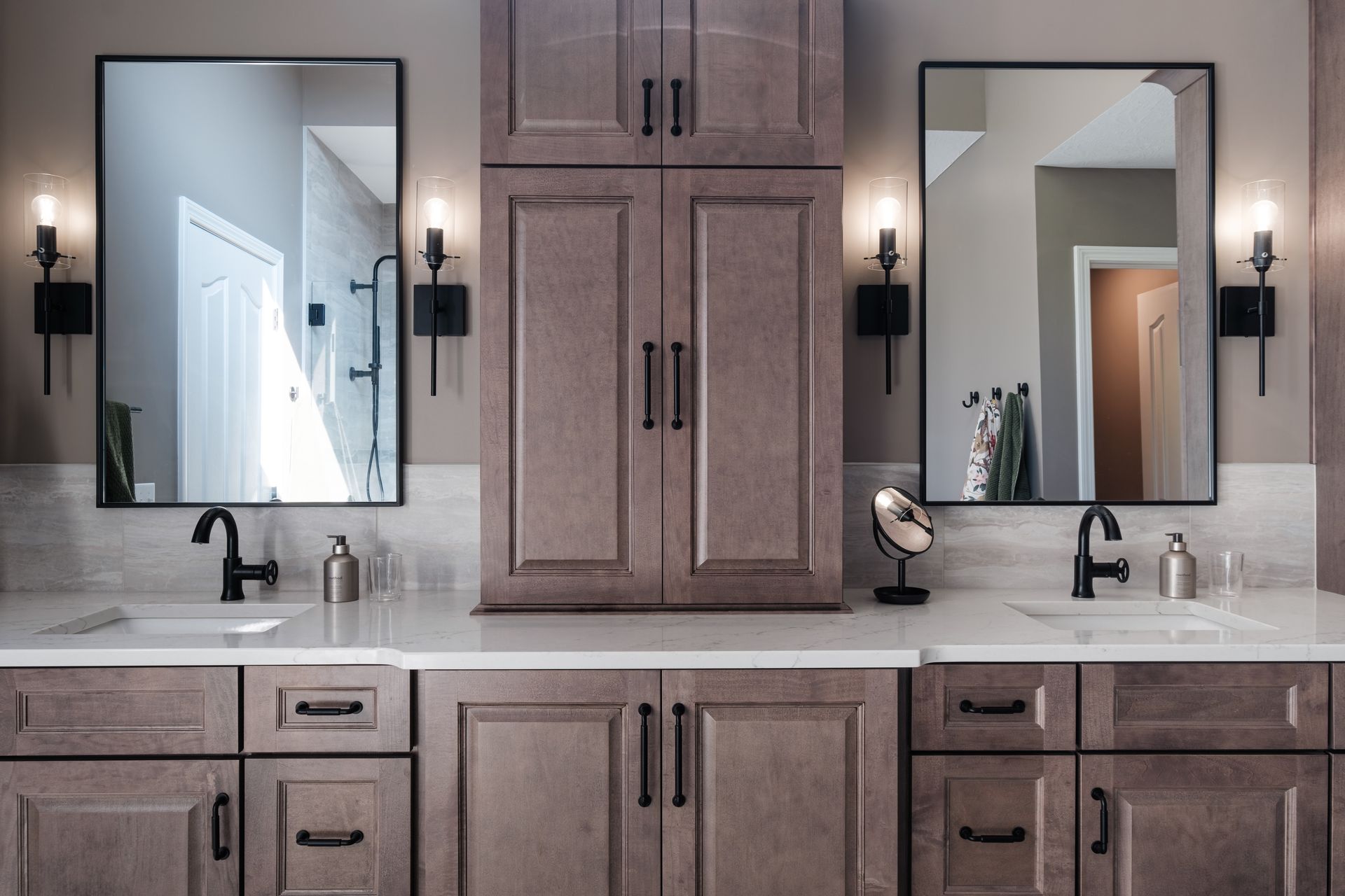 A bathroom with two sinks and two mirrors.