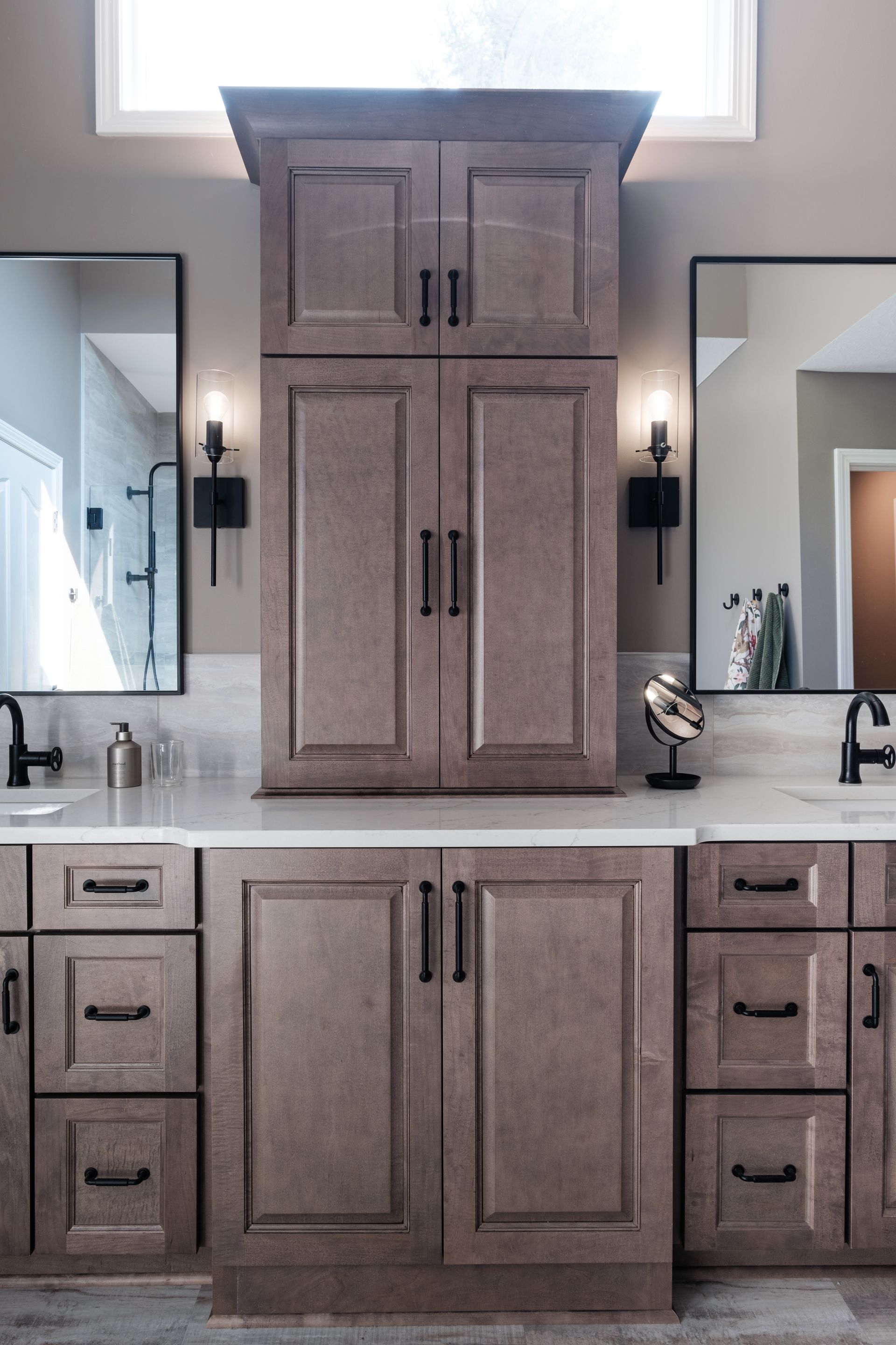 A bathroom with two sinks and two mirrors