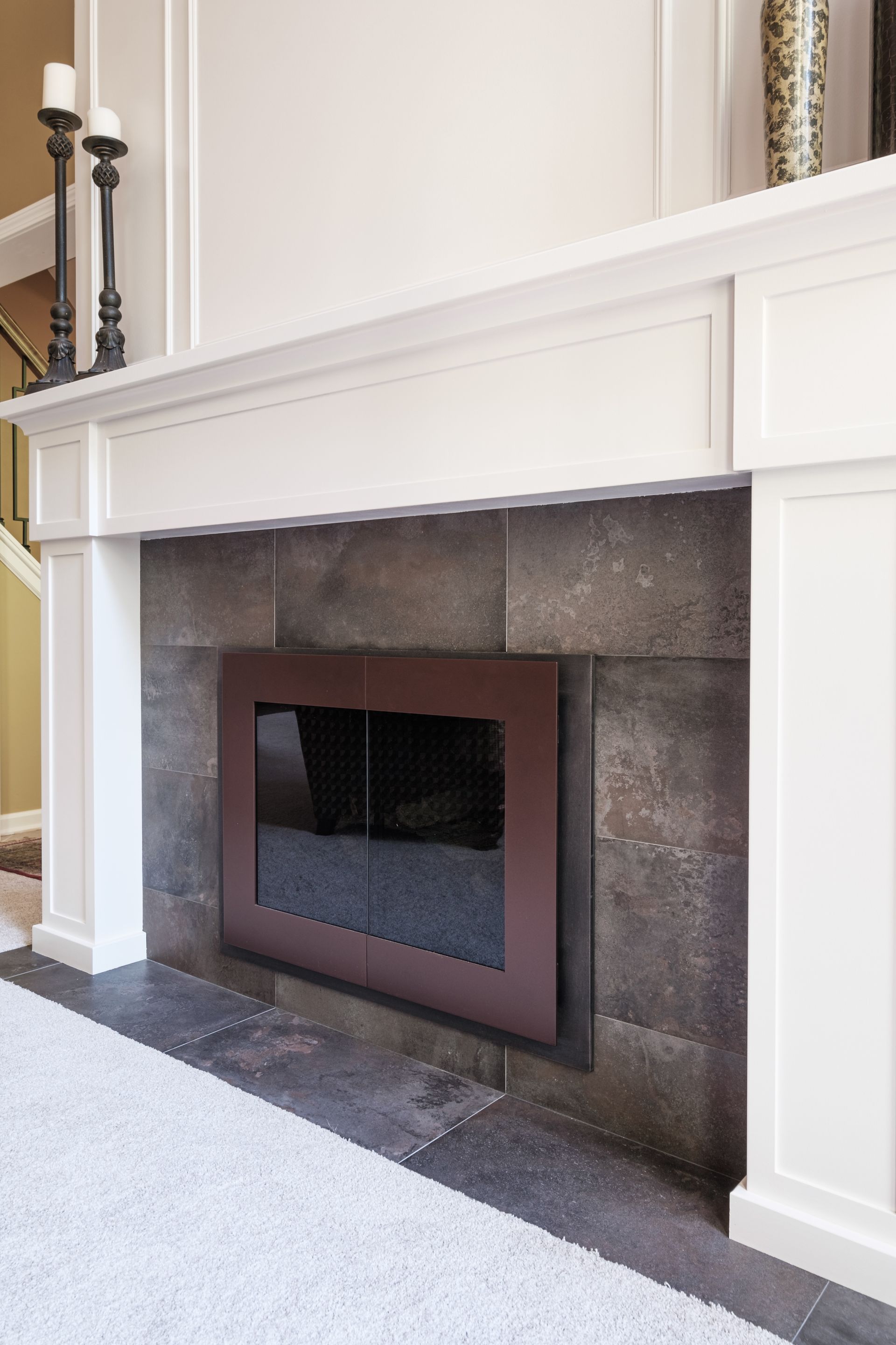 A living room with a fireplace and a white mantle