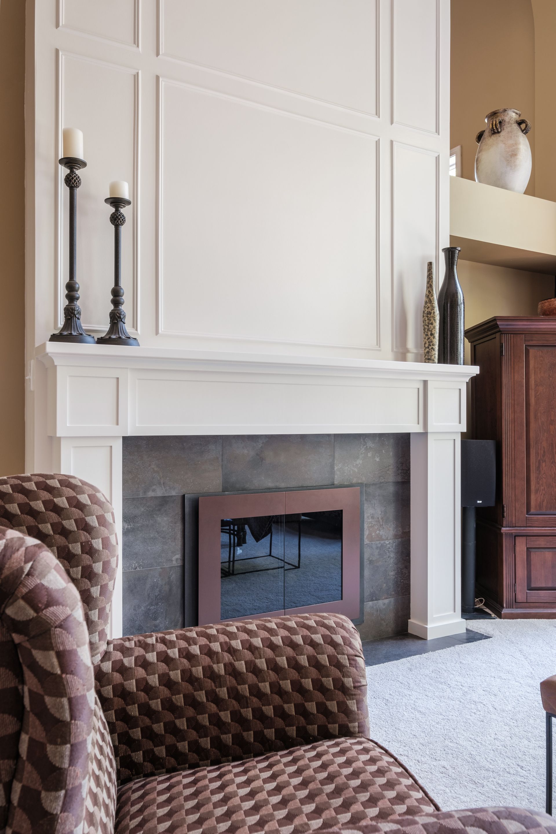 A living room with a fireplace and a chair