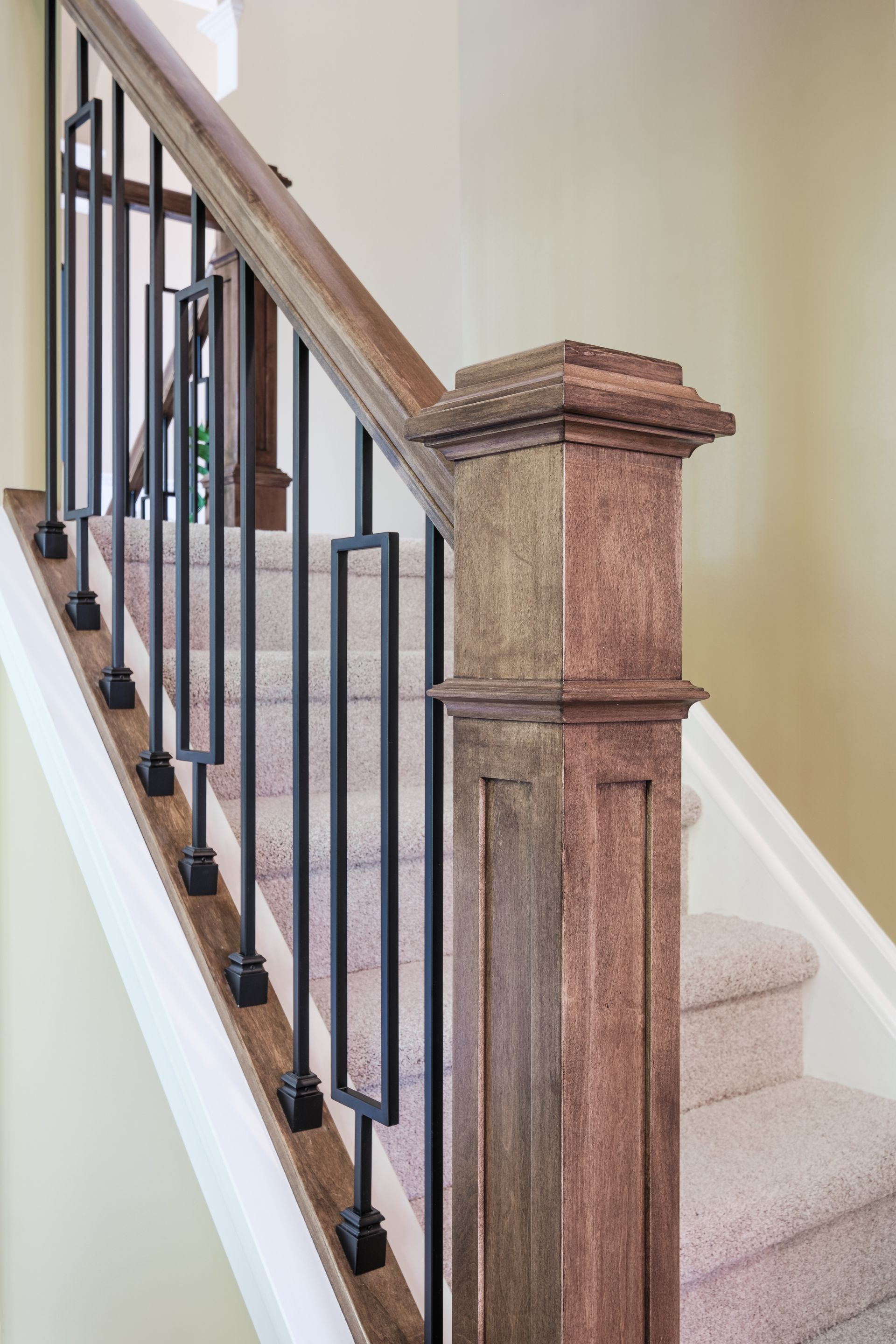 A staircase with a wooden railing and a carpeted staircase.
