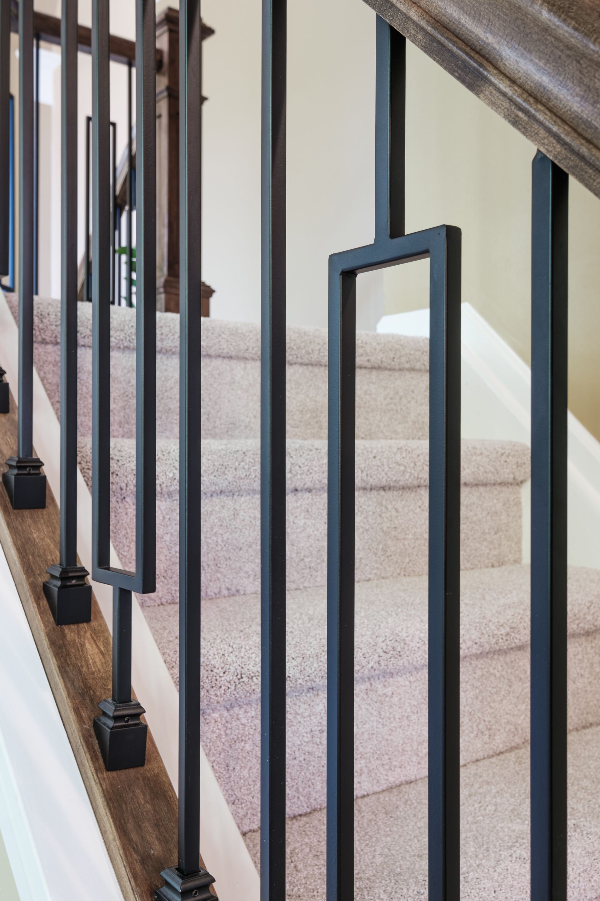 A close up of a metal railing on a set of stairs.