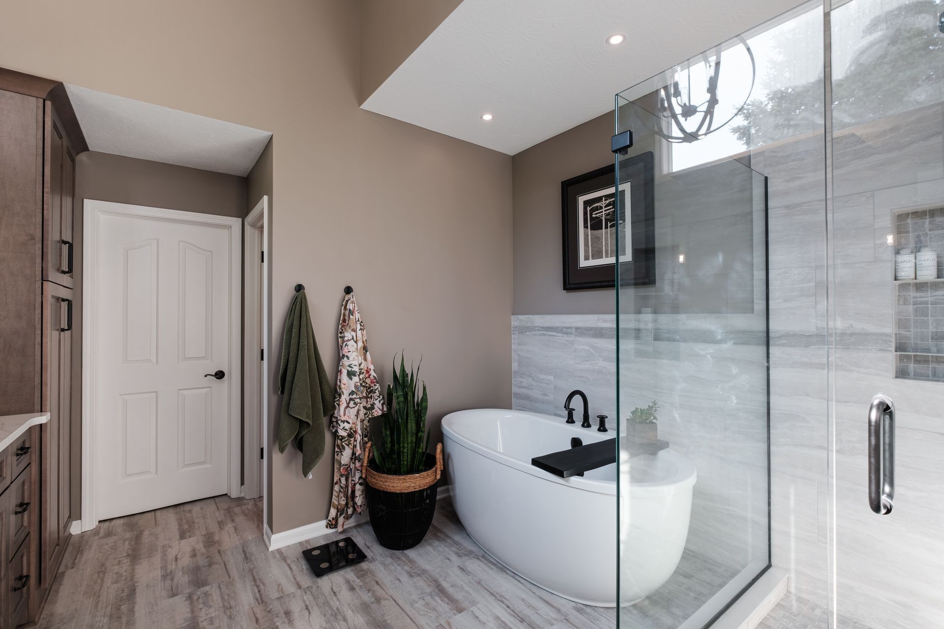 A bathroom with a tub and a walk in shower.