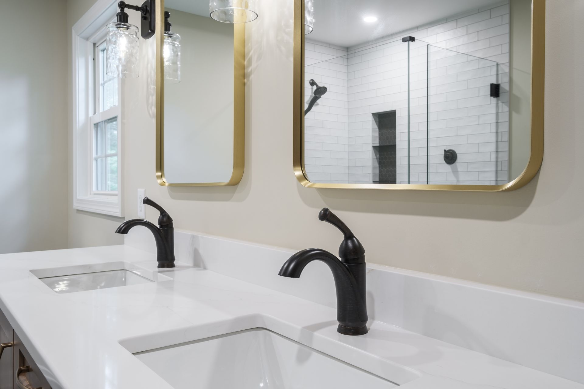 A bathroom with two sinks and two mirrors.