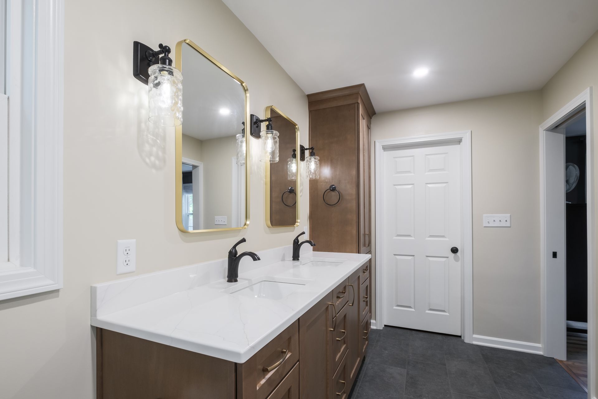 A bathroom with two sinks and two mirrors.