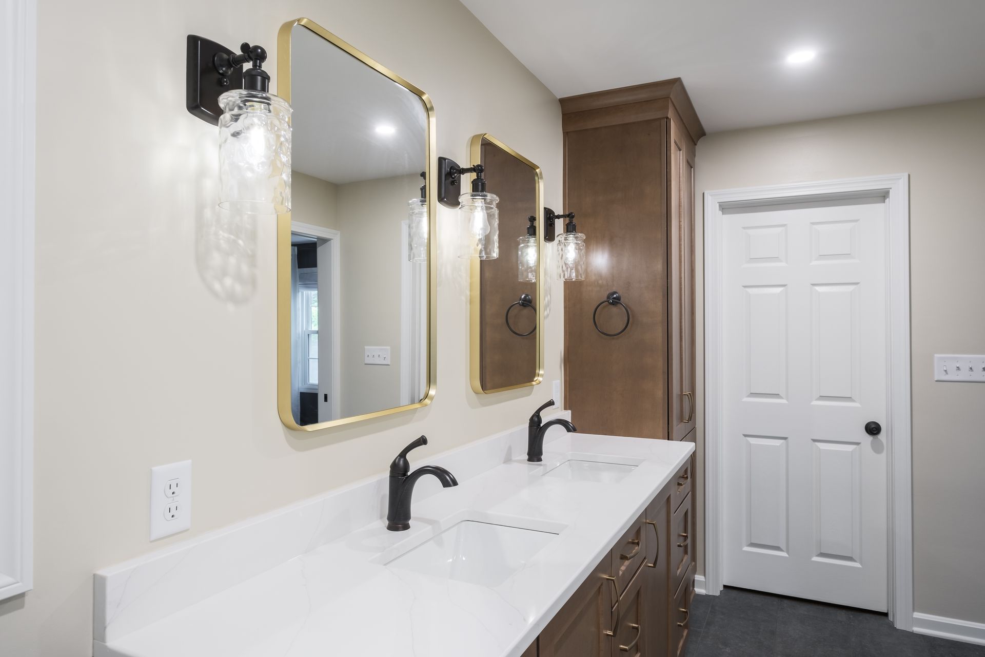 A bathroom with two sinks and two mirrors.