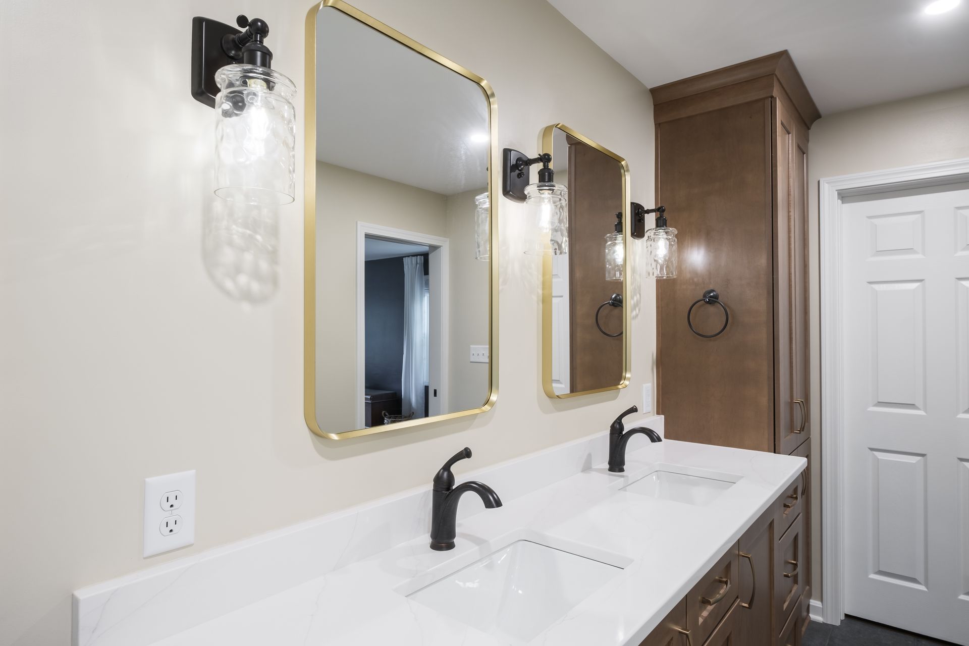 A bathroom with two sinks and two mirrors.