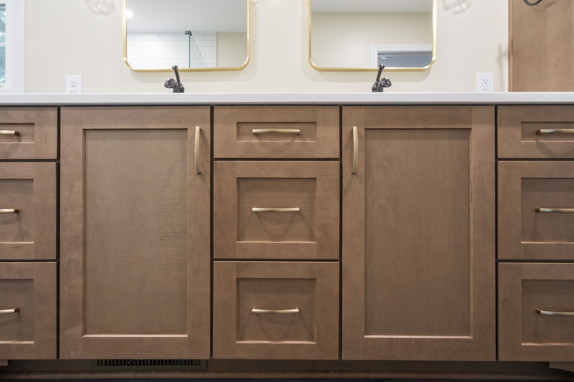 A bathroom vanity with two sinks and two mirrors.