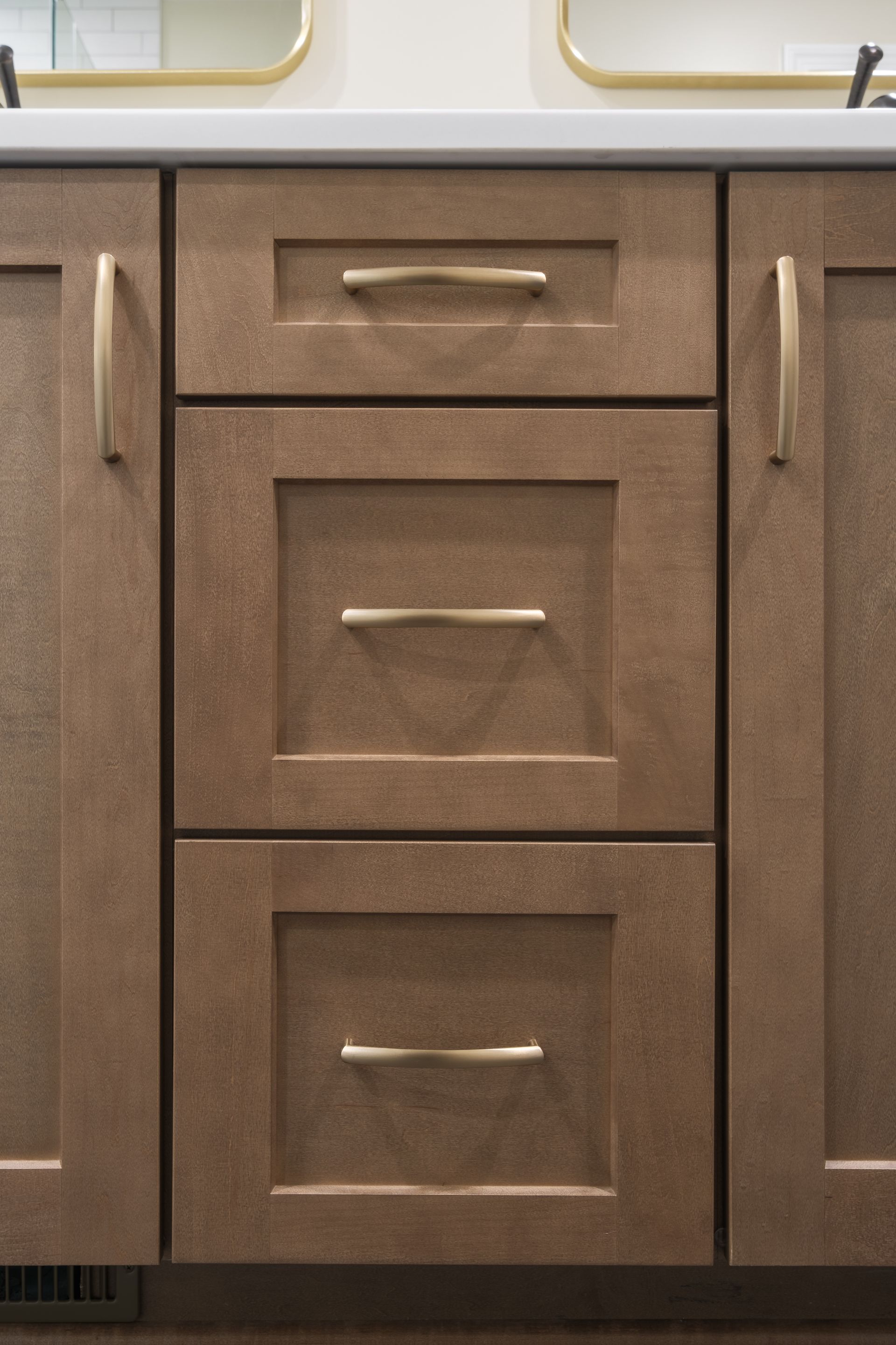 A bathroom vanity with two sinks and three drawers