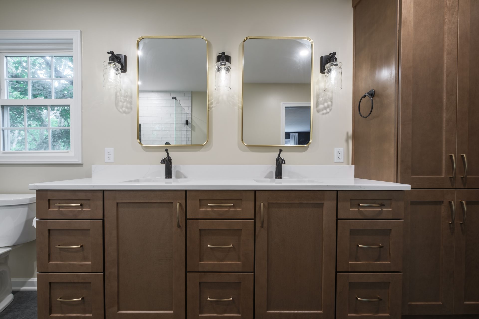 A bathroom with two sinks and two mirrors.
