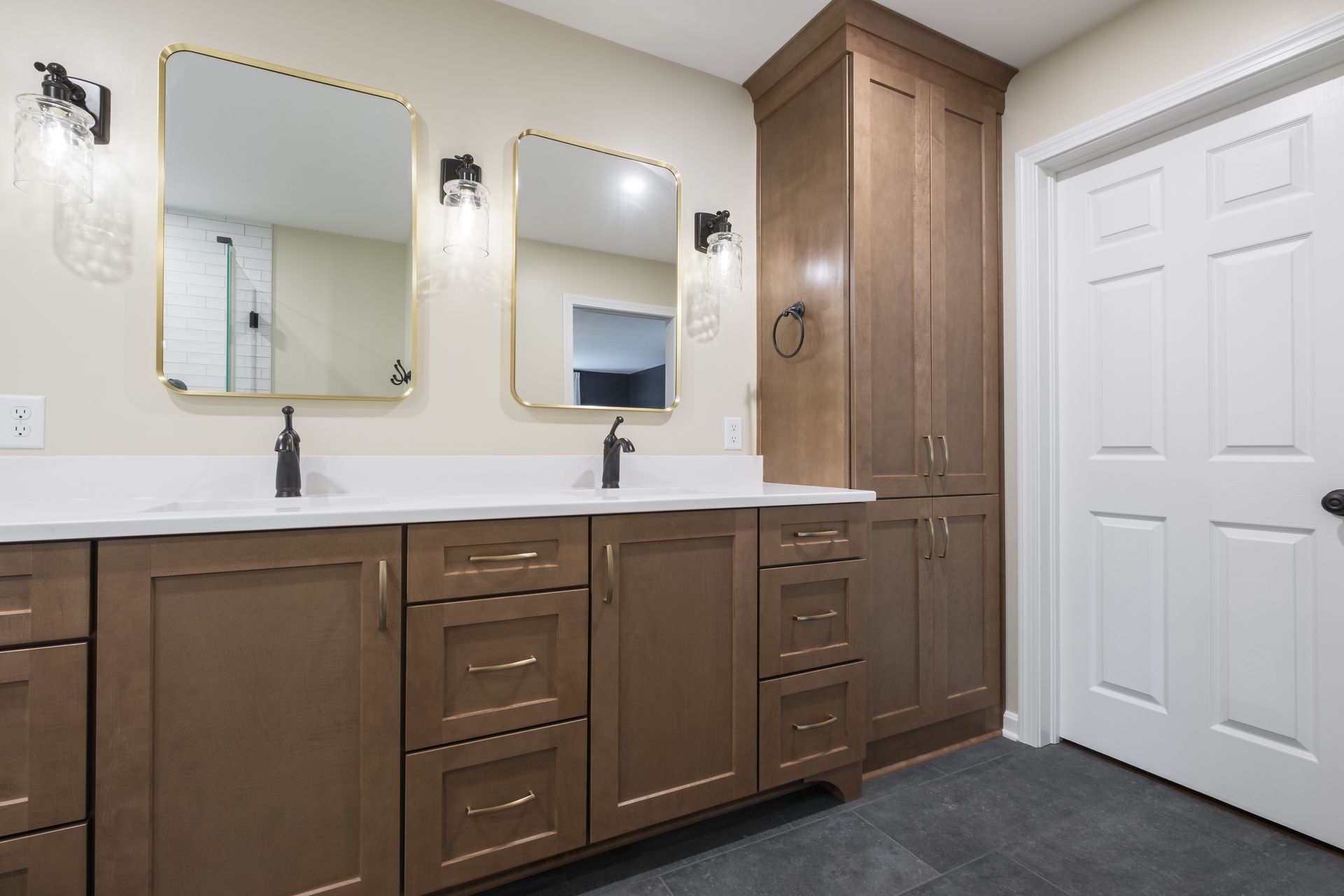 A bathroom with two sinks and two mirrors.