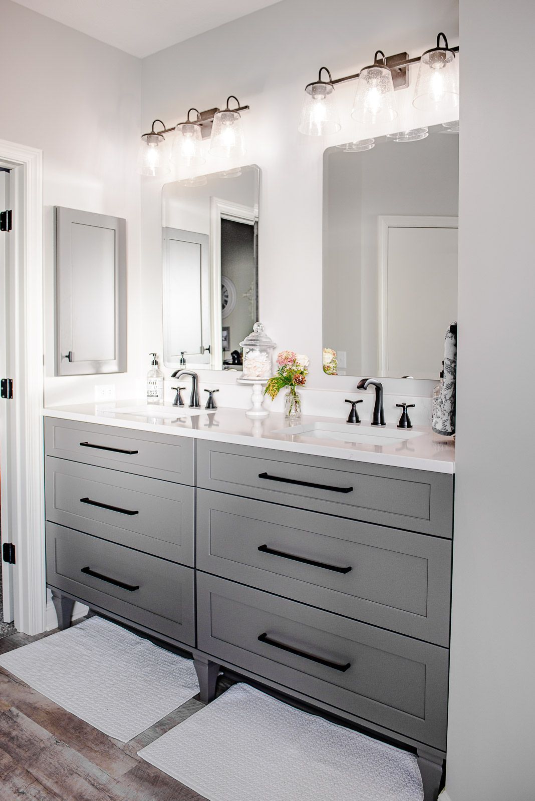 A bathroom with two sinks and two mirrors.