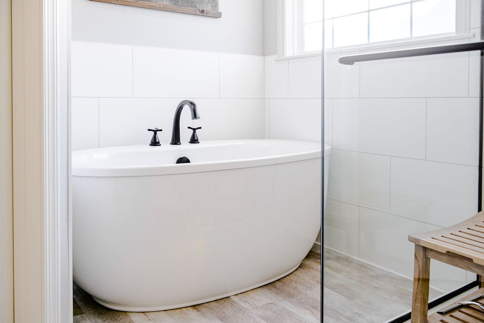 A bathroom with a bathtub and a walk in shower.