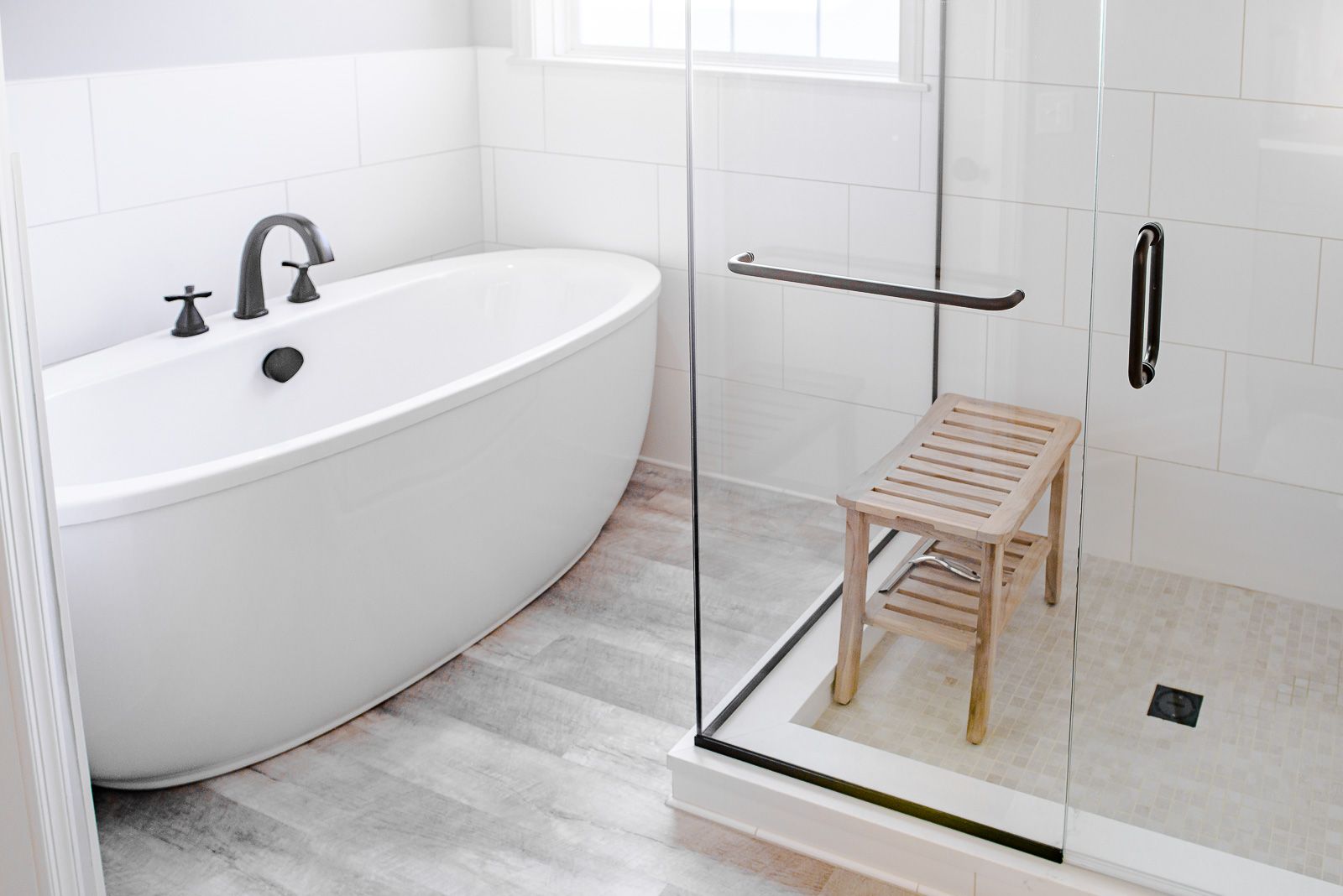 A bathroom with a bathtub and a walk in shower.