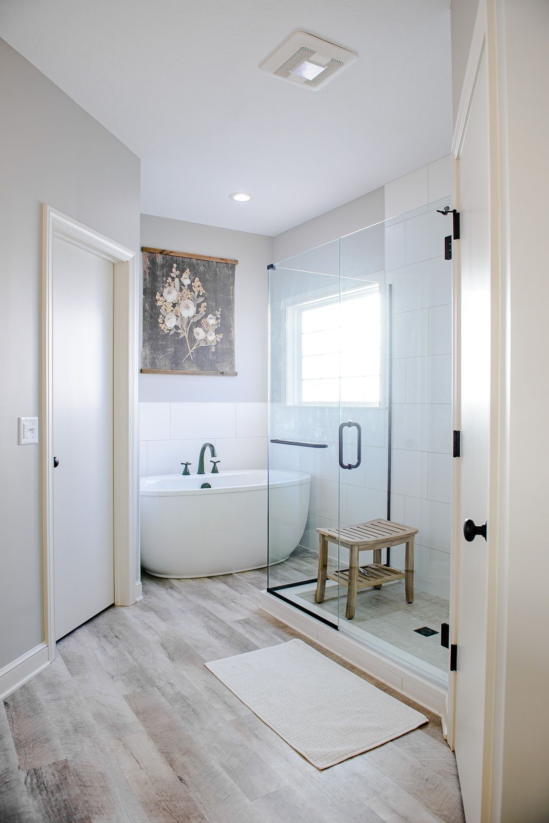 A bathroom with a tub and a walk in shower.