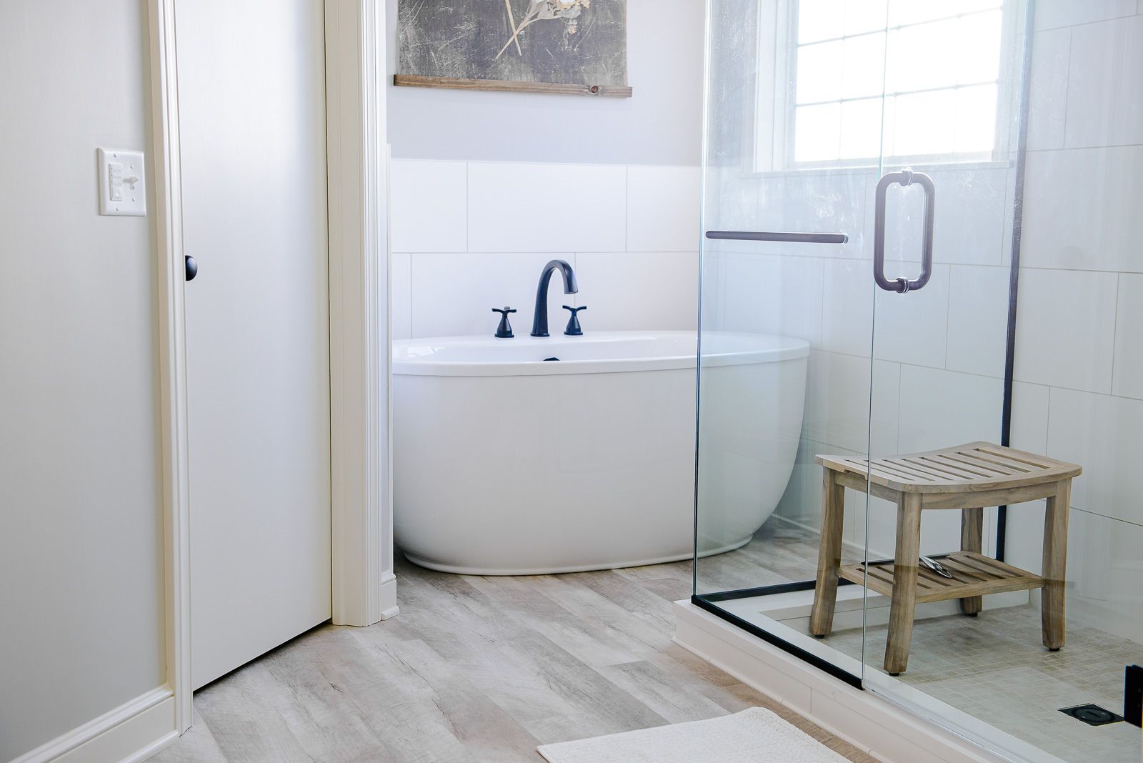 A bathroom with a bathtub and a walk in shower.