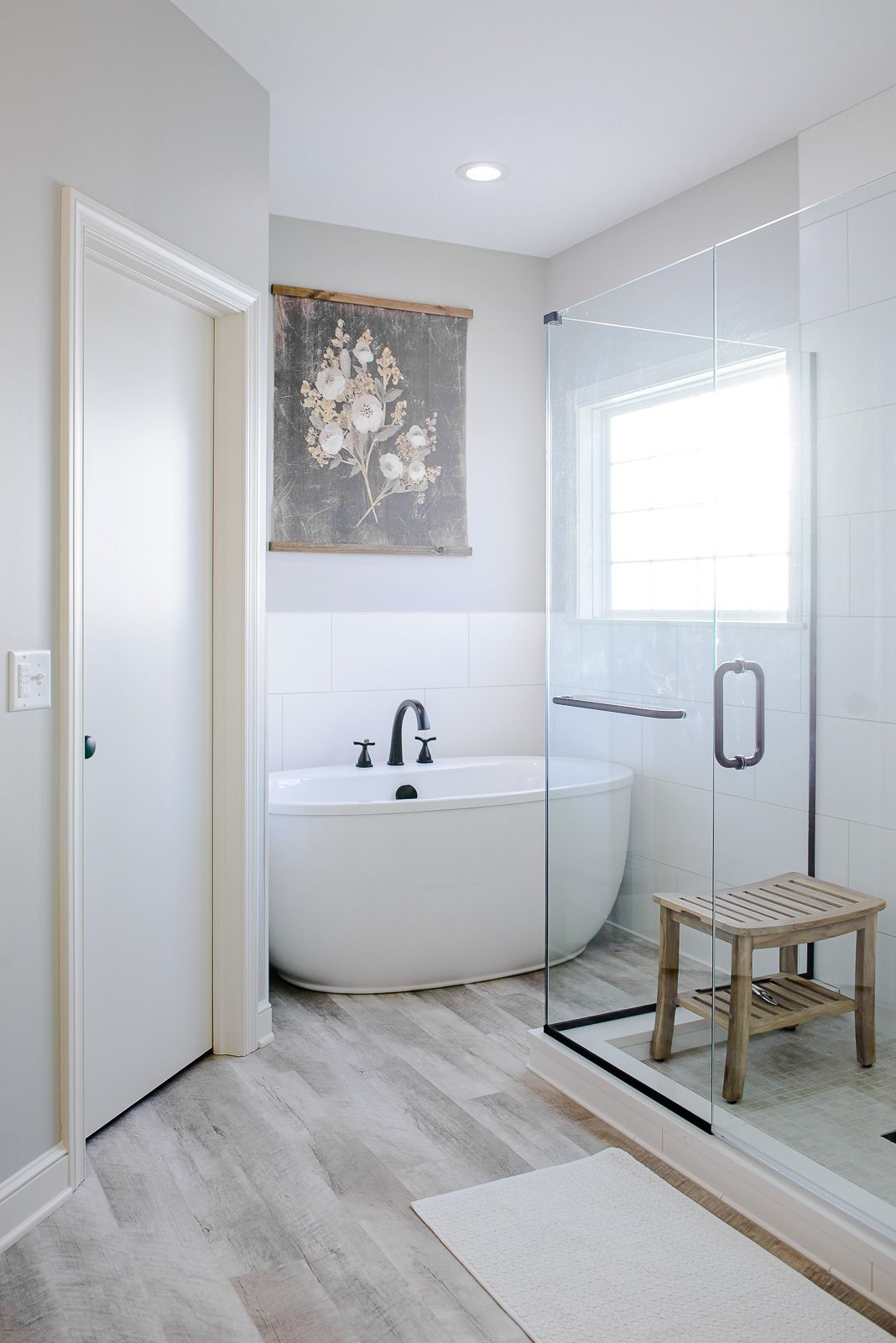 A bathroom with a bathtub and a walk in shower.
