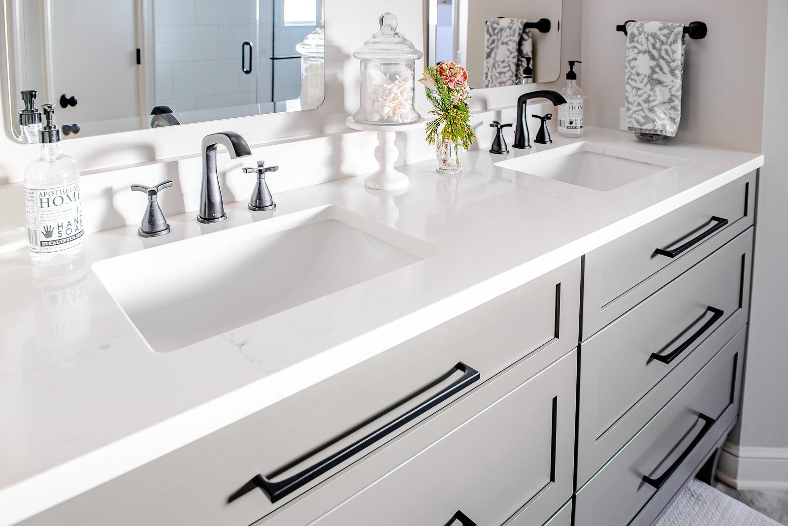 A bathroom with two sinks and a mirror.