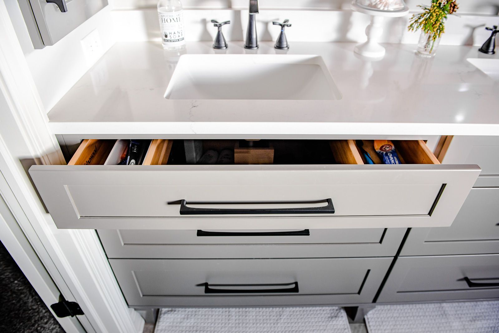 A bathroom vanity with drawers open and a sink.