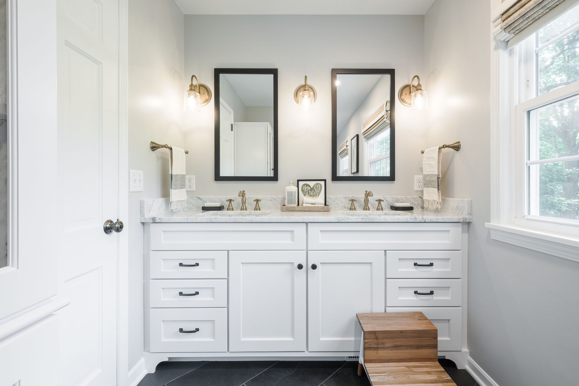A bathroom with two sinks and two mirrors.