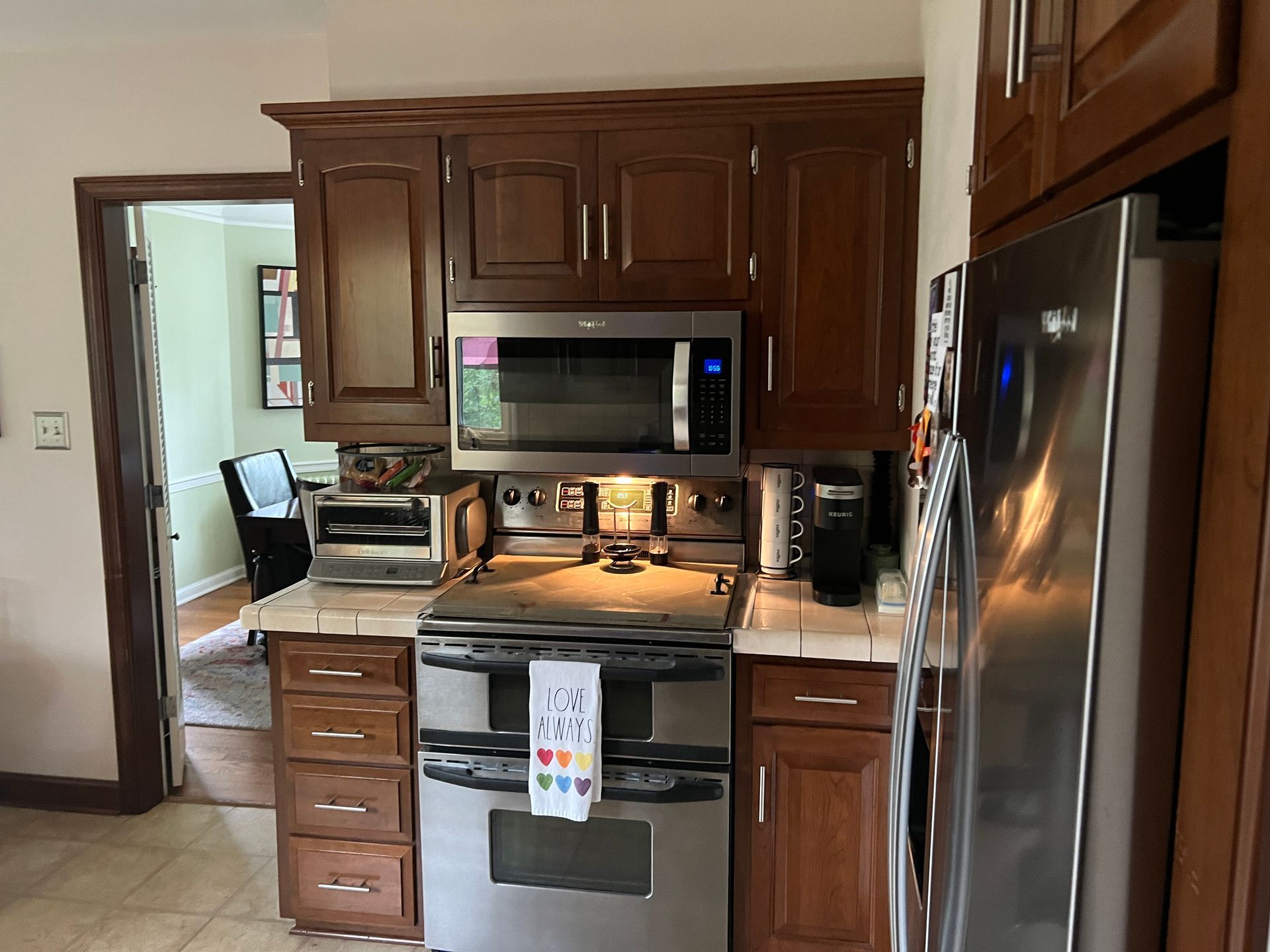 A kitchen with stainless steel appliances and wooden cabinets