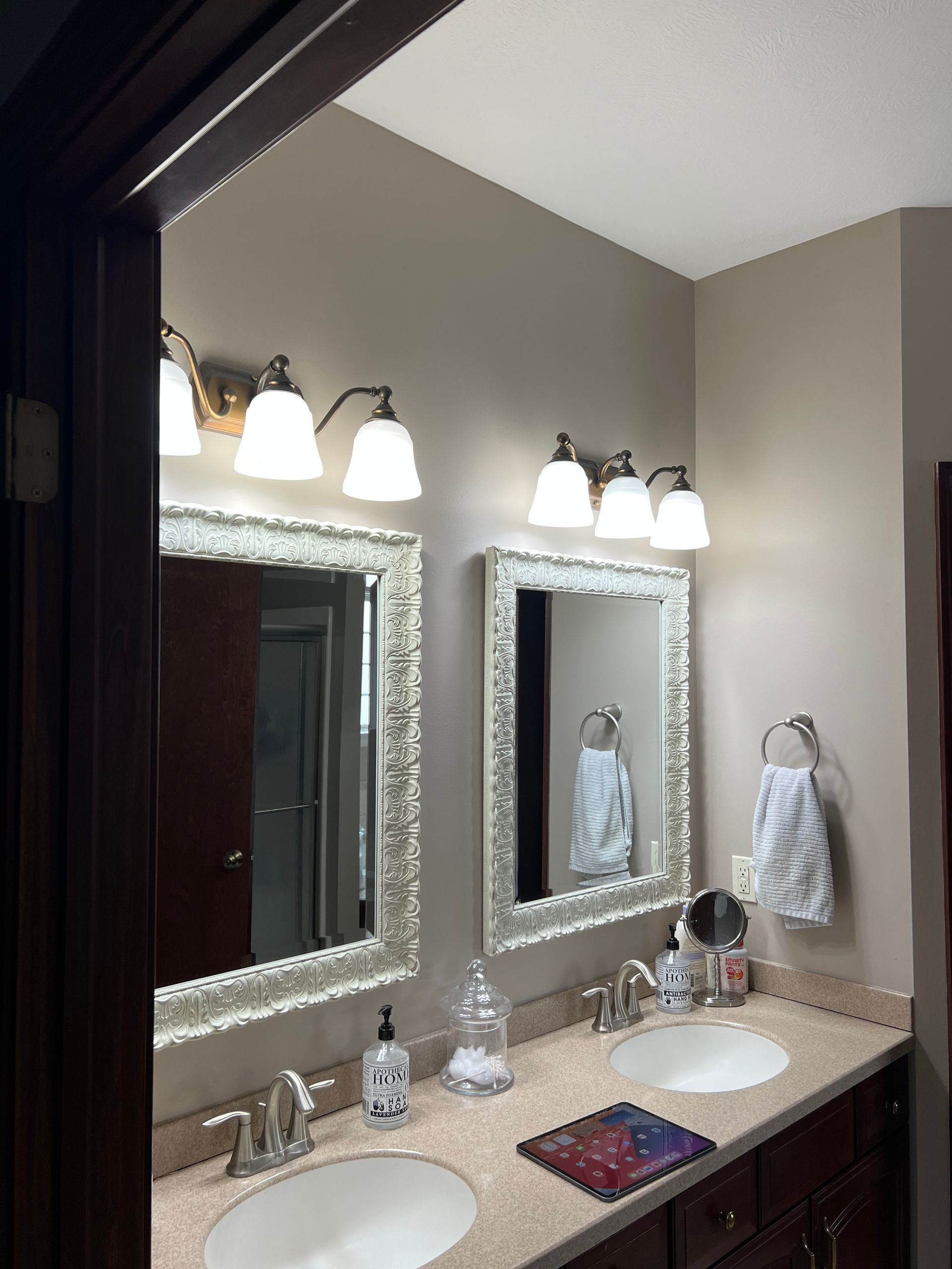 A bathroom with two sinks and two mirrors