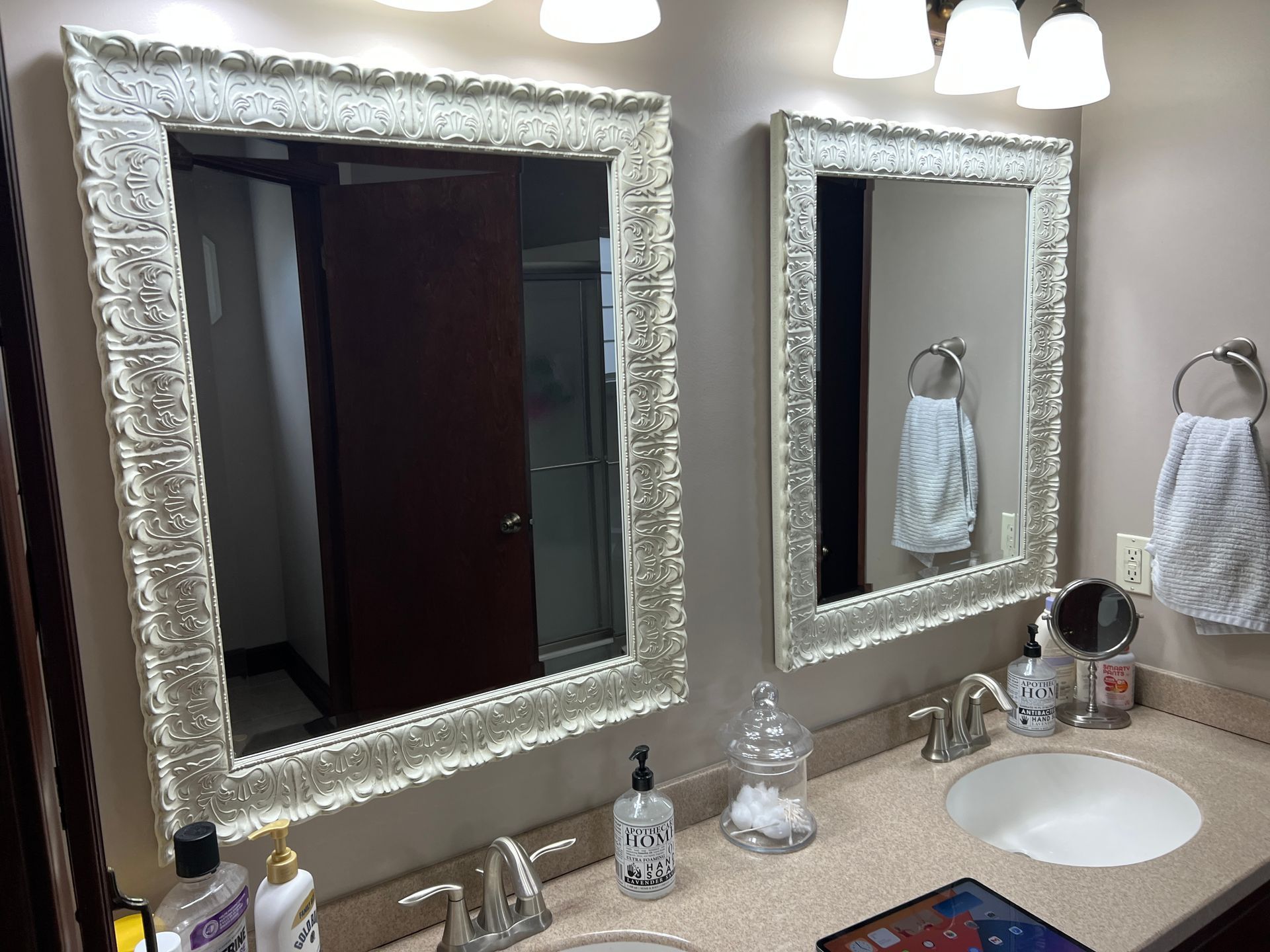 A bathroom with two sinks and two mirrors