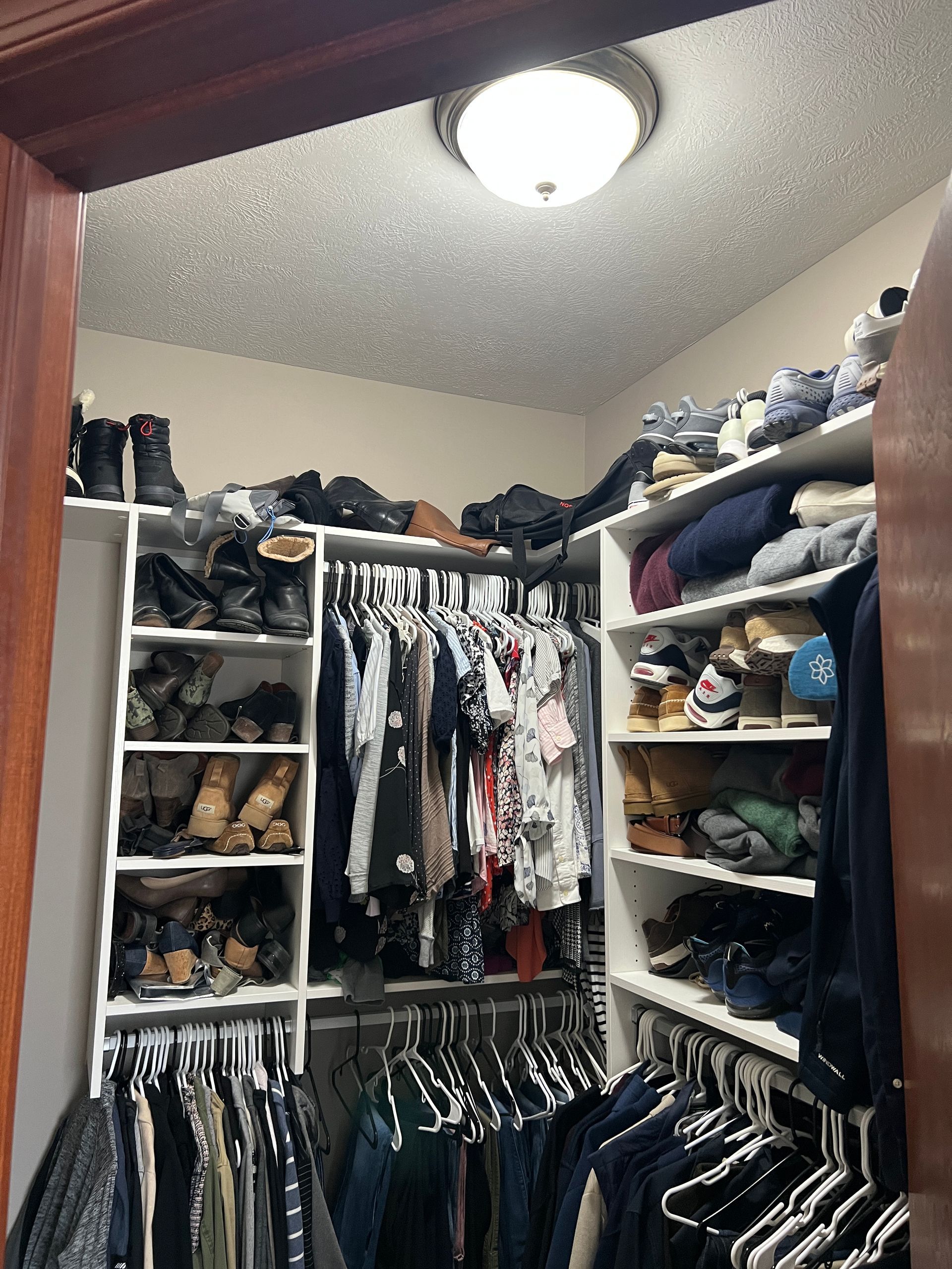 A walk in closet filled with clothes and shoes