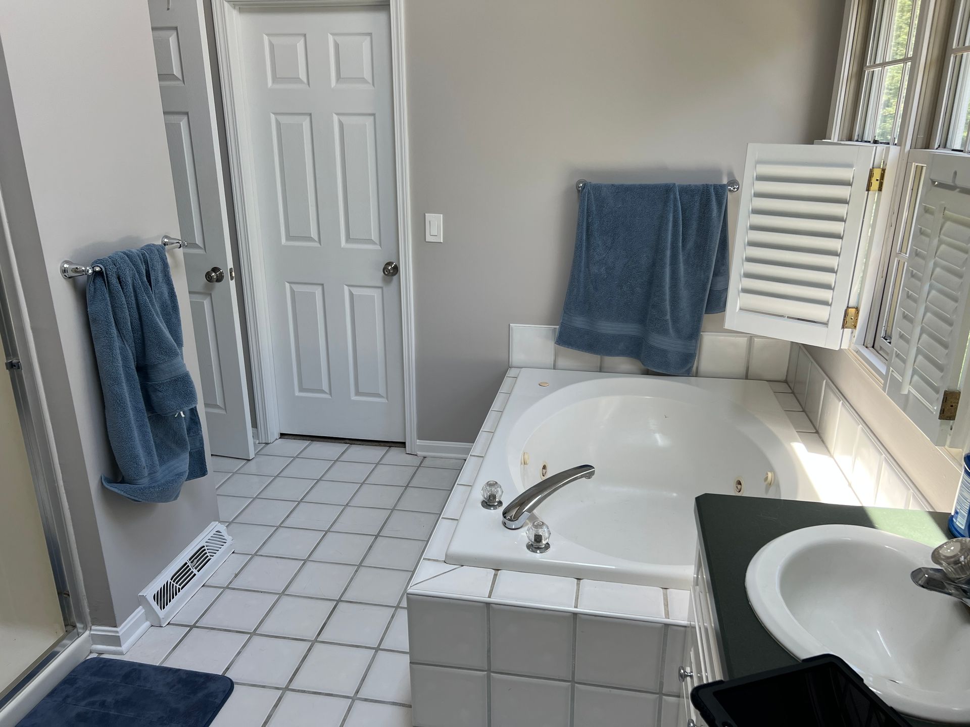 A bathroom with a jacuzzi tub and a sink