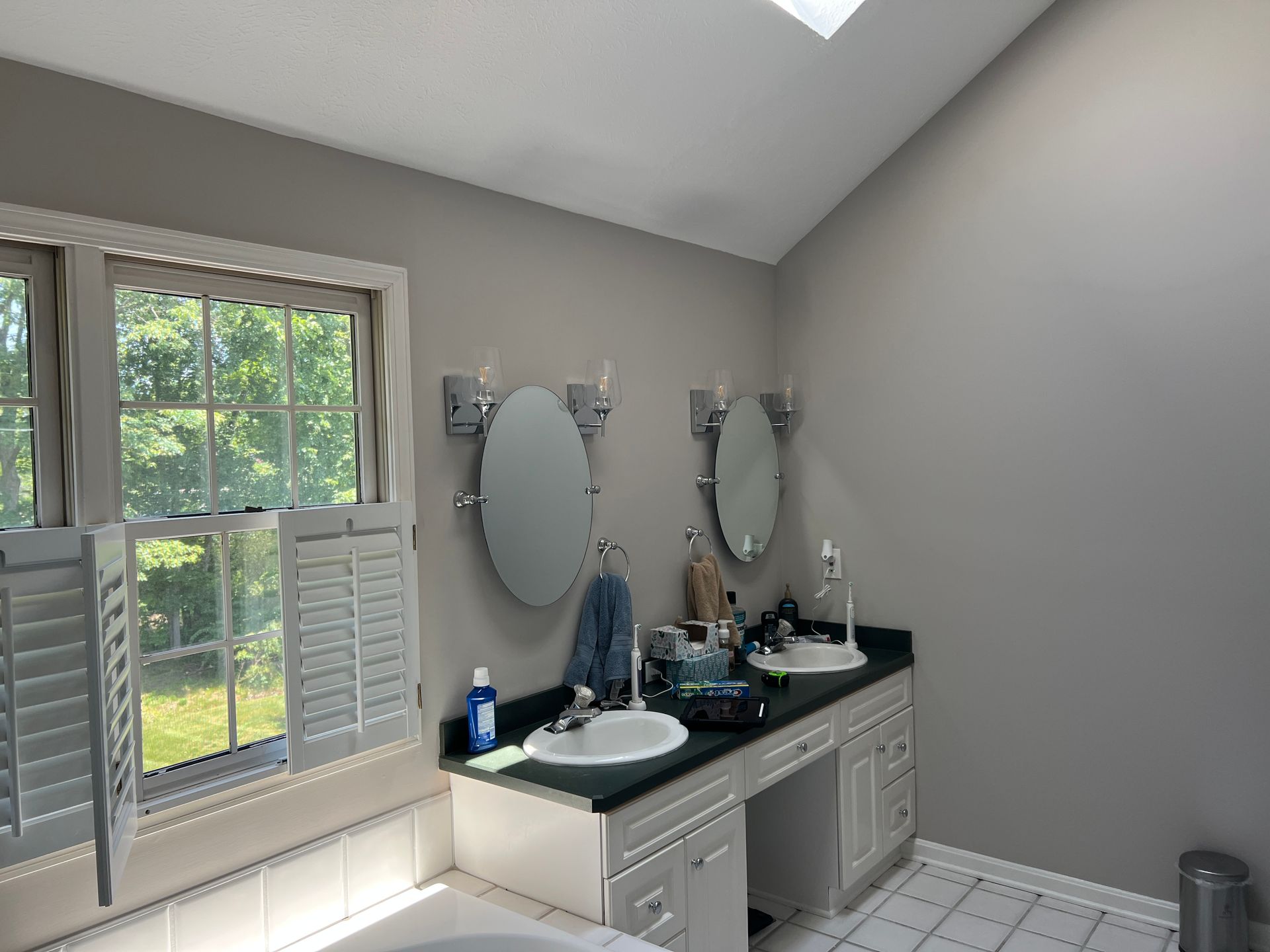A bathroom with two sinks and two mirrors