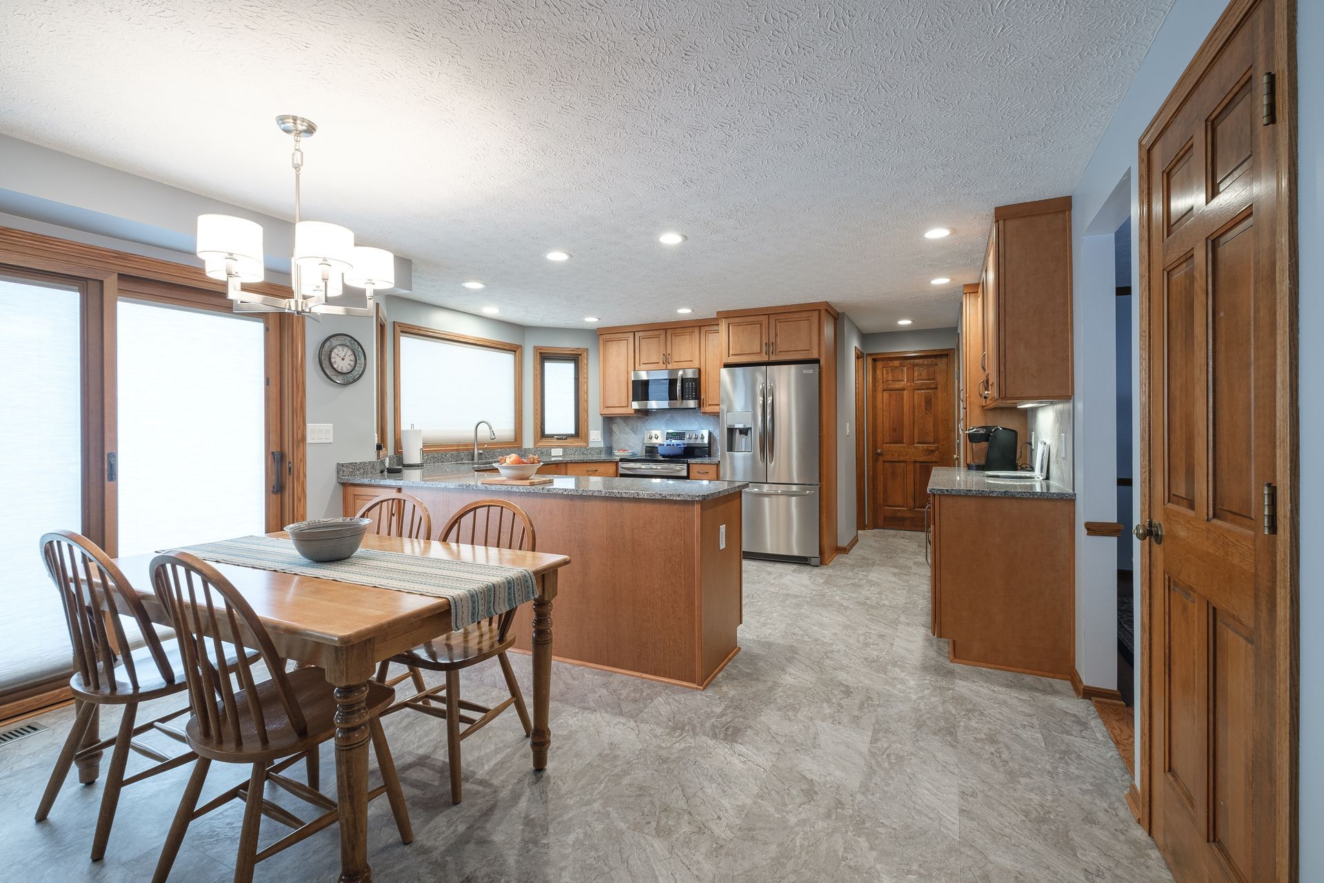 A kitchen with a table and chairs in it