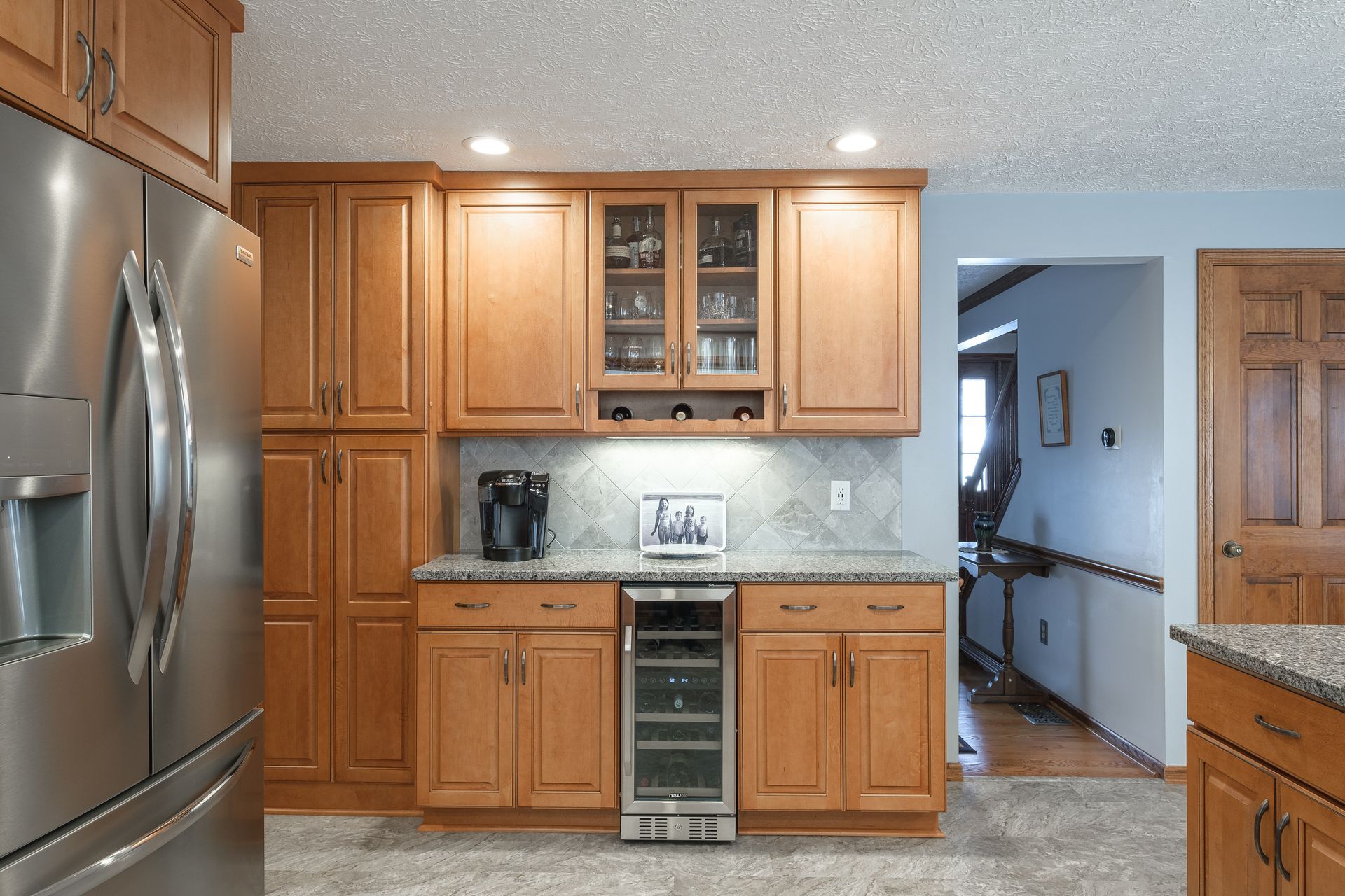 A kitchen with wooden cabinets and stainless steel appliances