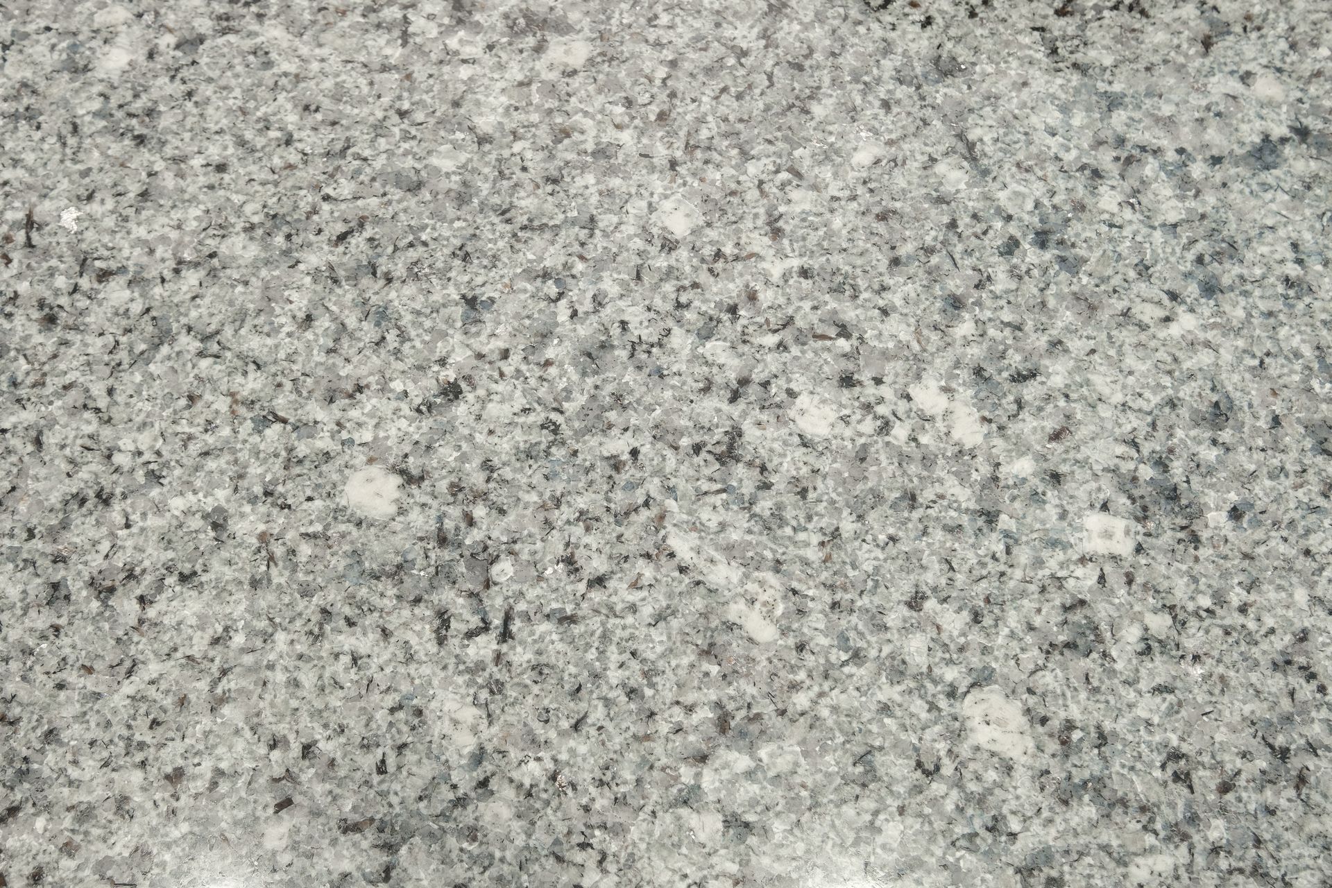 A close up of a gray granite counter top.
