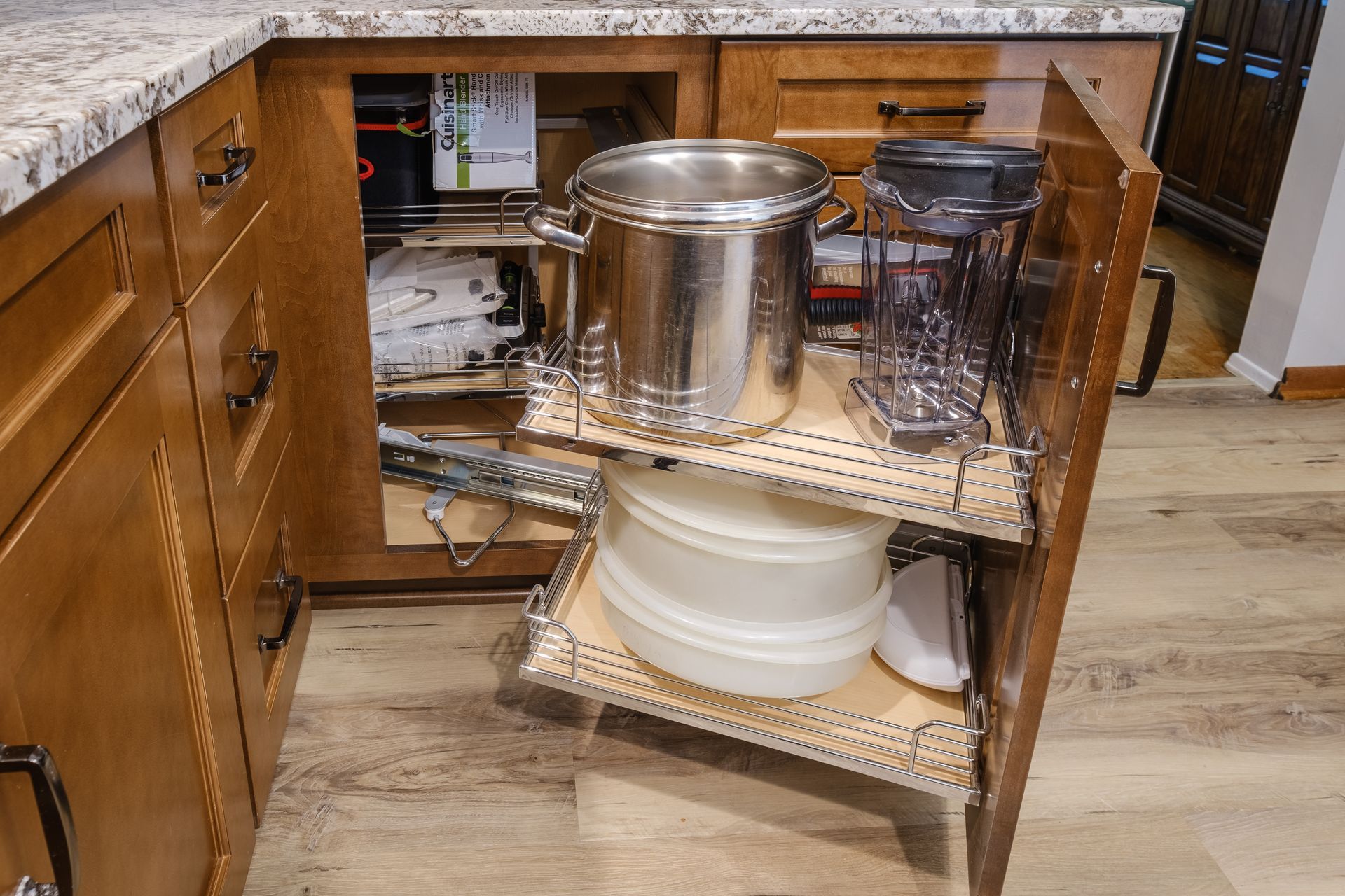 A kitchen cabinet with a corner shelf filled with pots and pans.