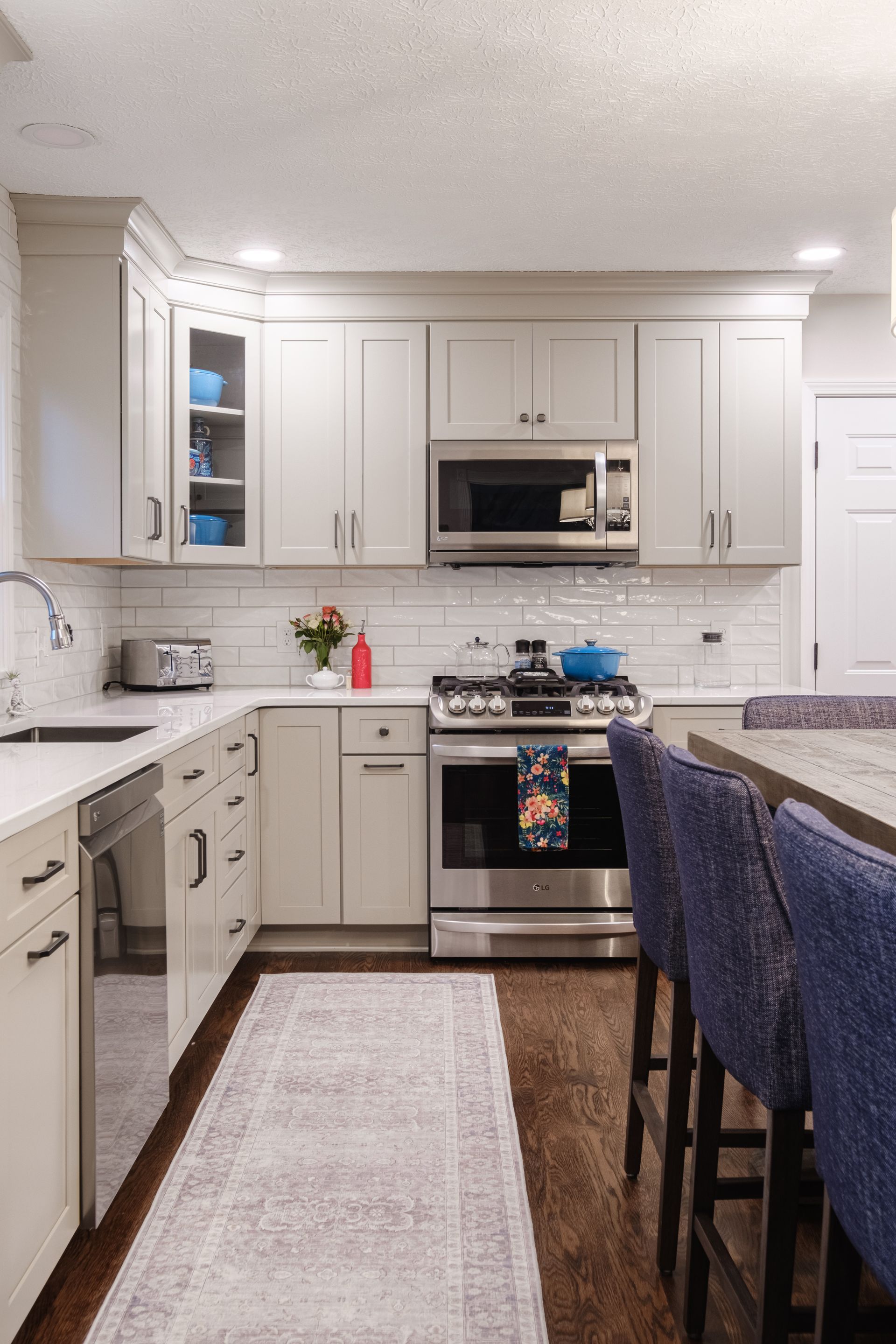 A kitchen with white cabinets and stainless steel appliances